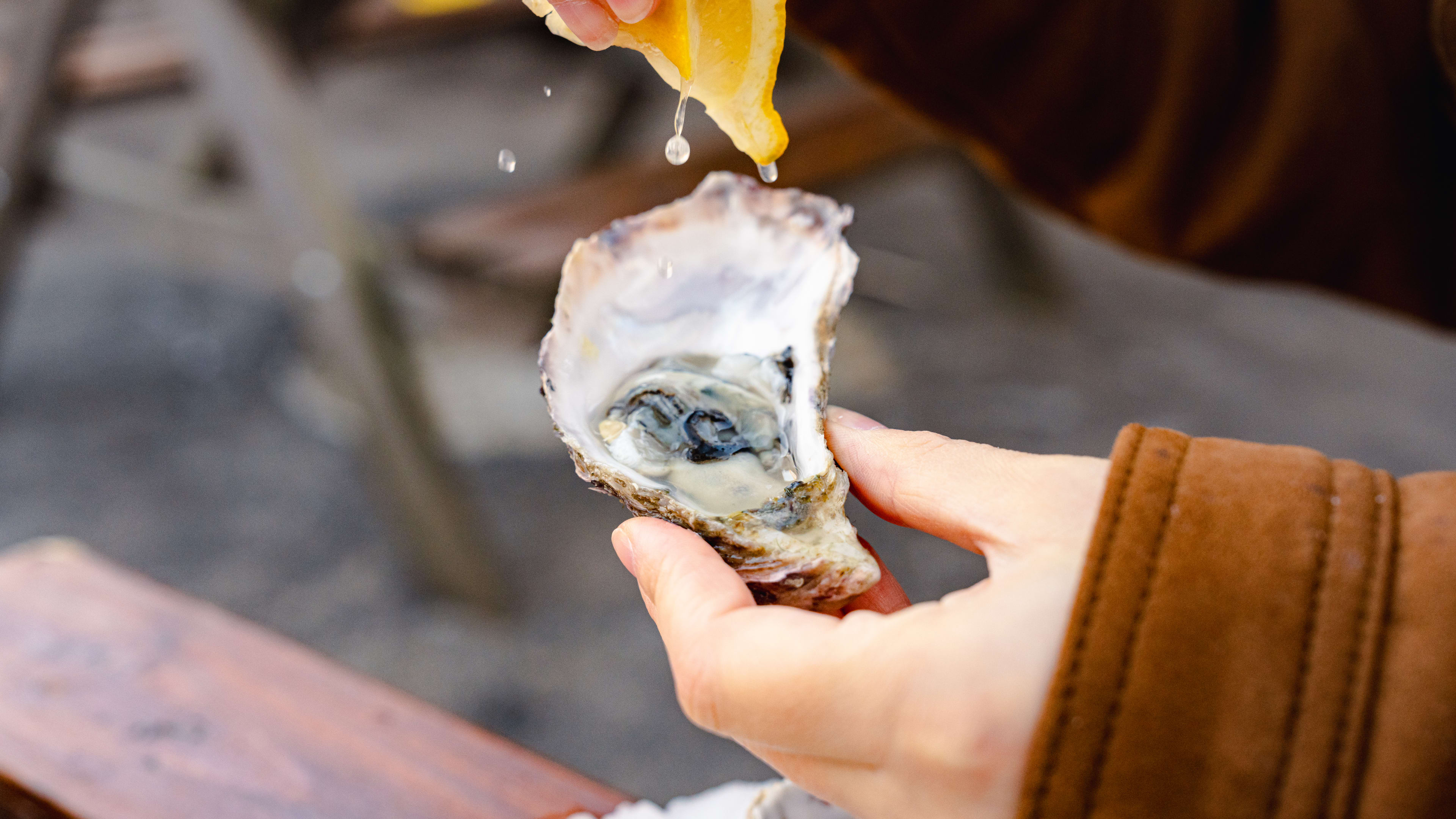 Lemon squeezed over an oyster.