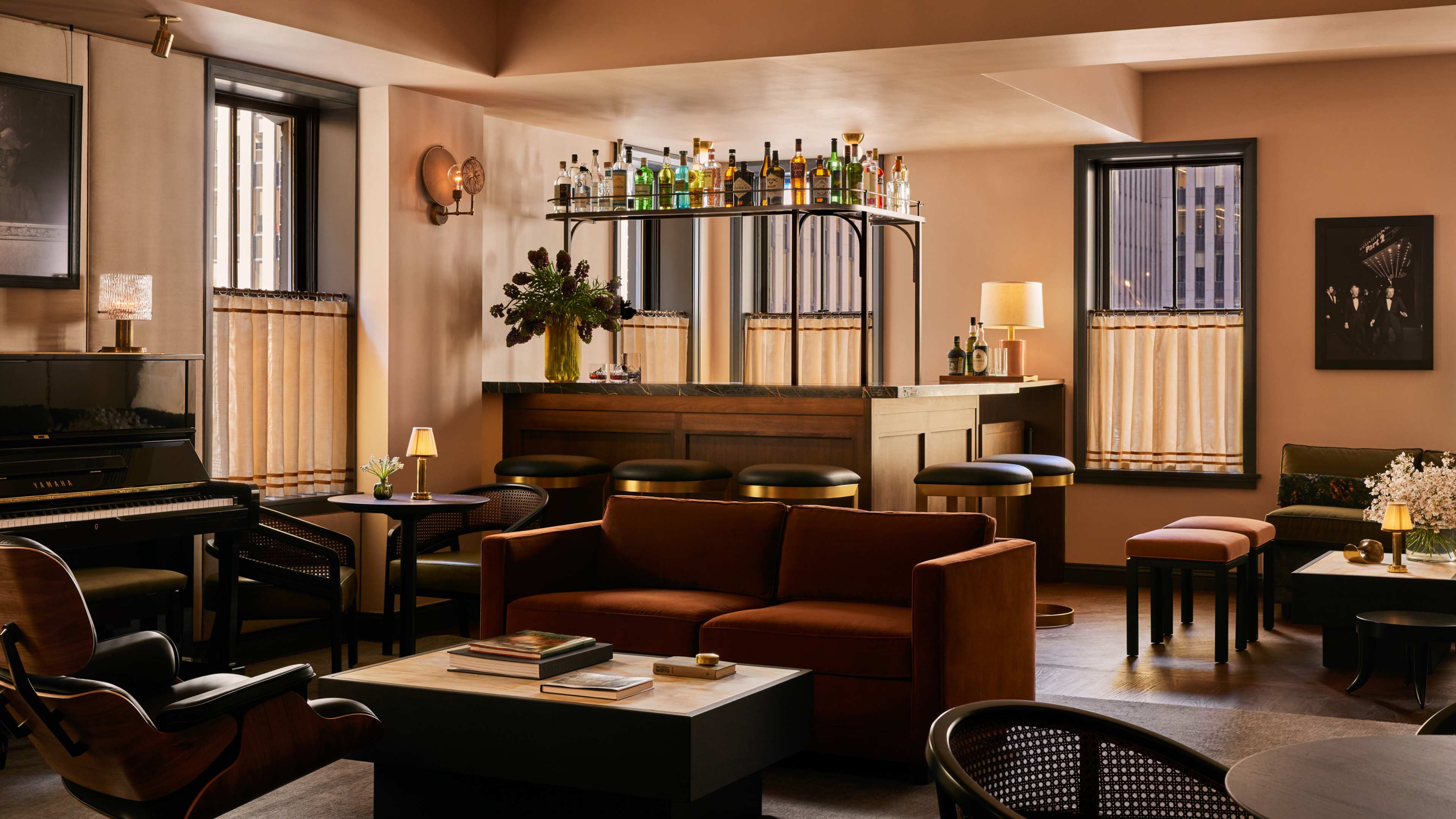 The interior of the fourth floor of Pebble Bar. There is earth toned living room furniture among tables and chairs.