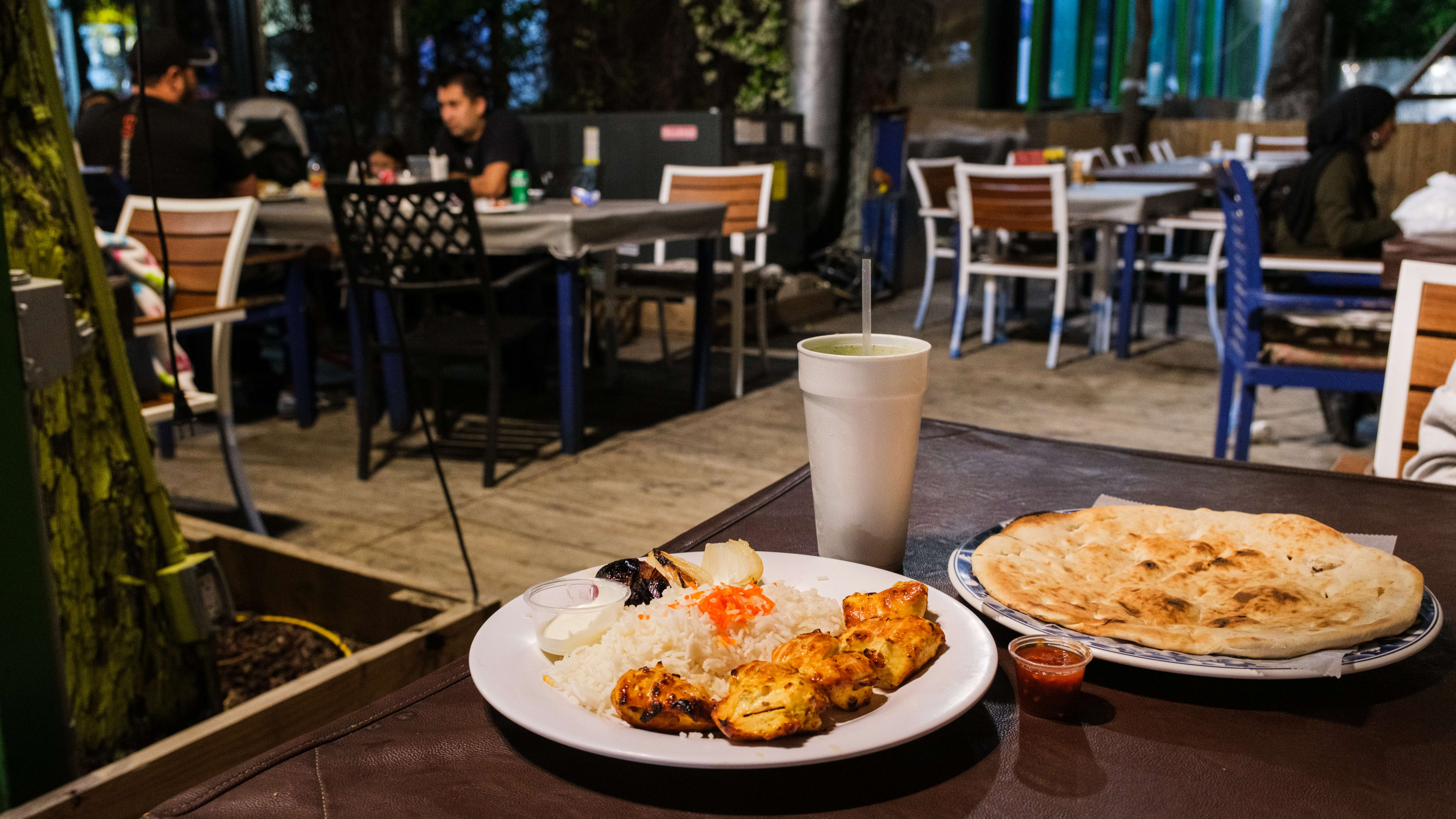 A spread of dishes on a table on the patio at Ranosh Cafe.