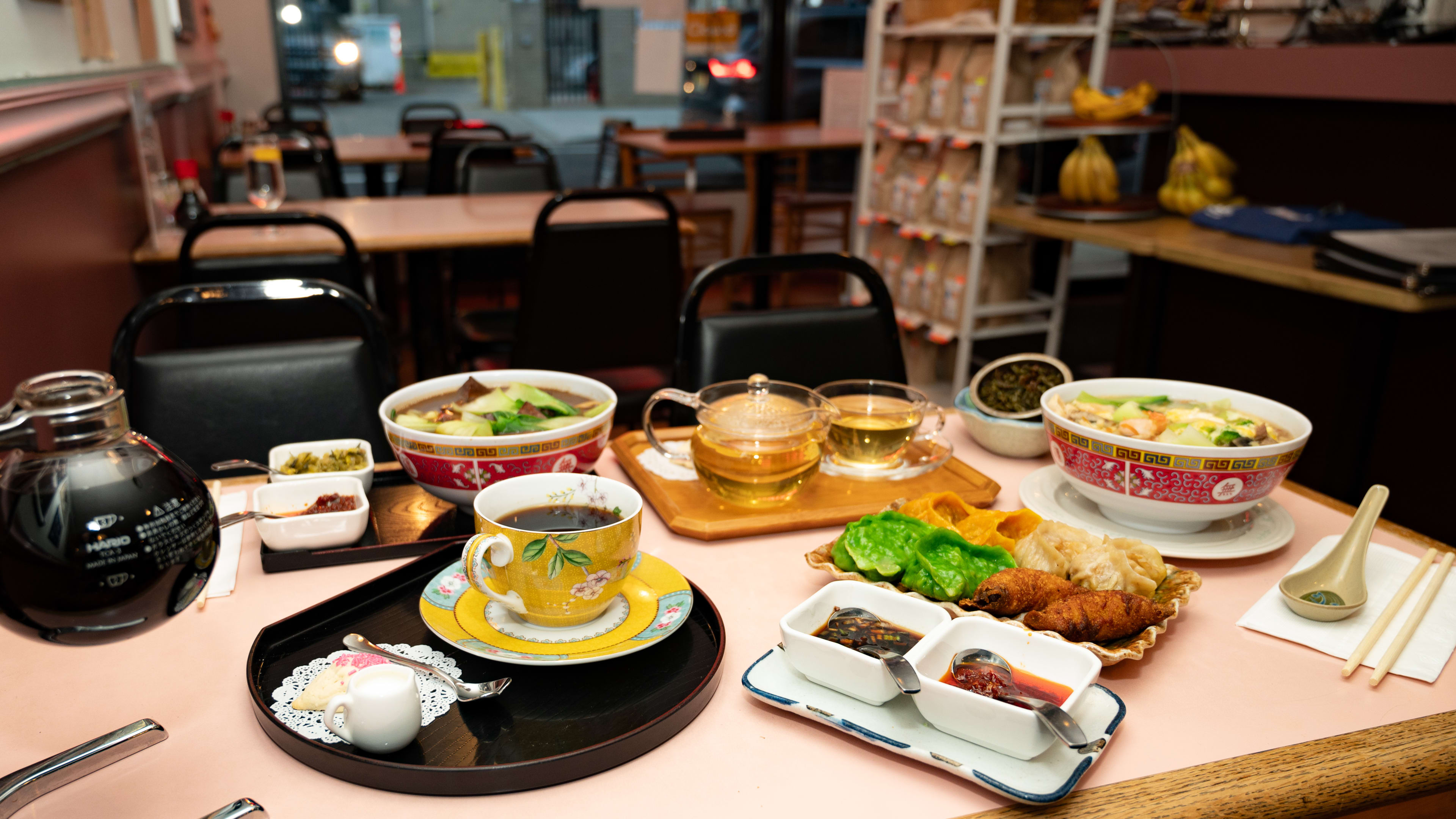 This is the food spread at Ray's Tea Cafe, which includes dumplings, tea, siphon coffee, and noodle soup.