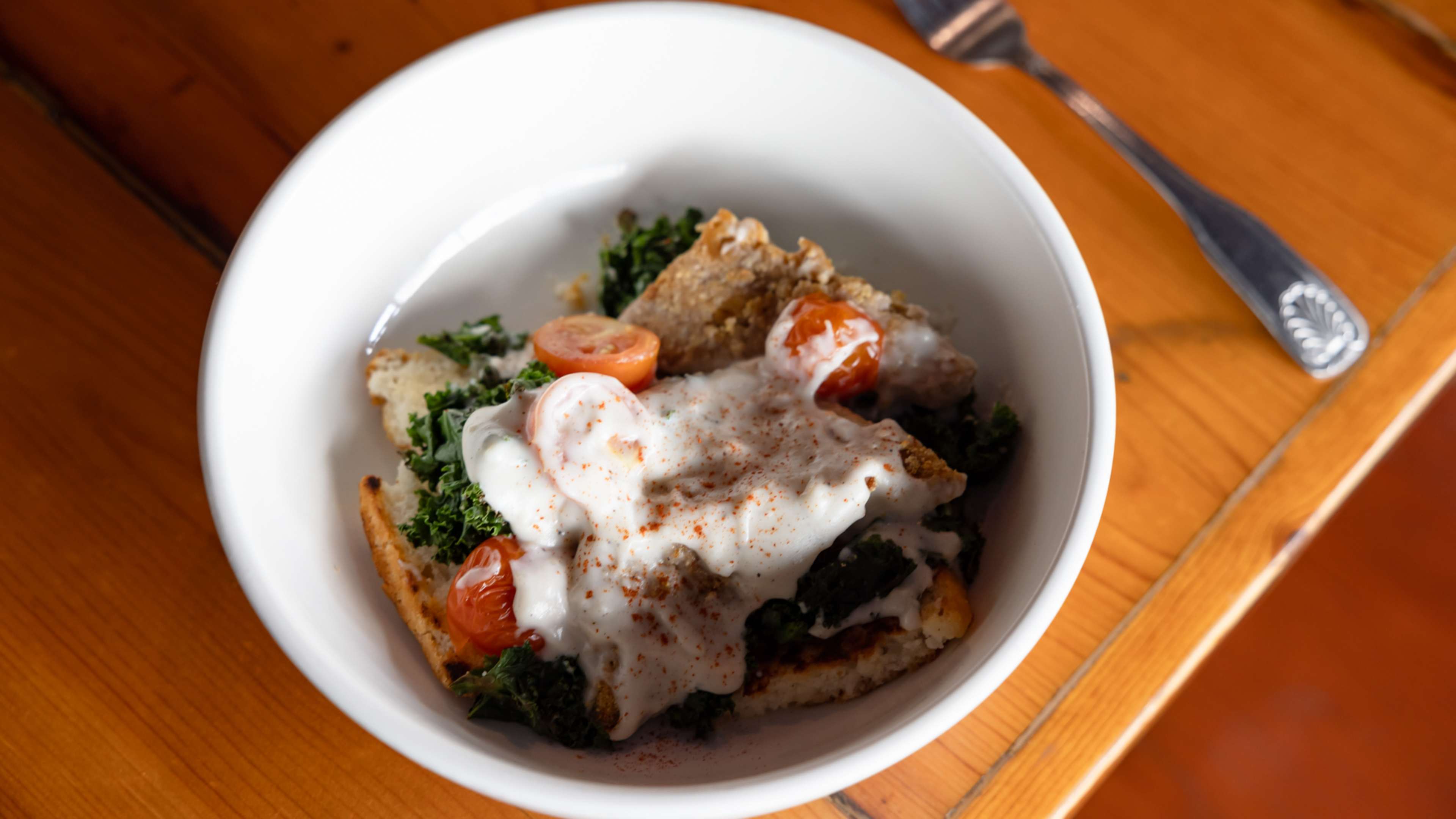 Country Fried Tempeh with white pepper gravy, tomatoes, and kale