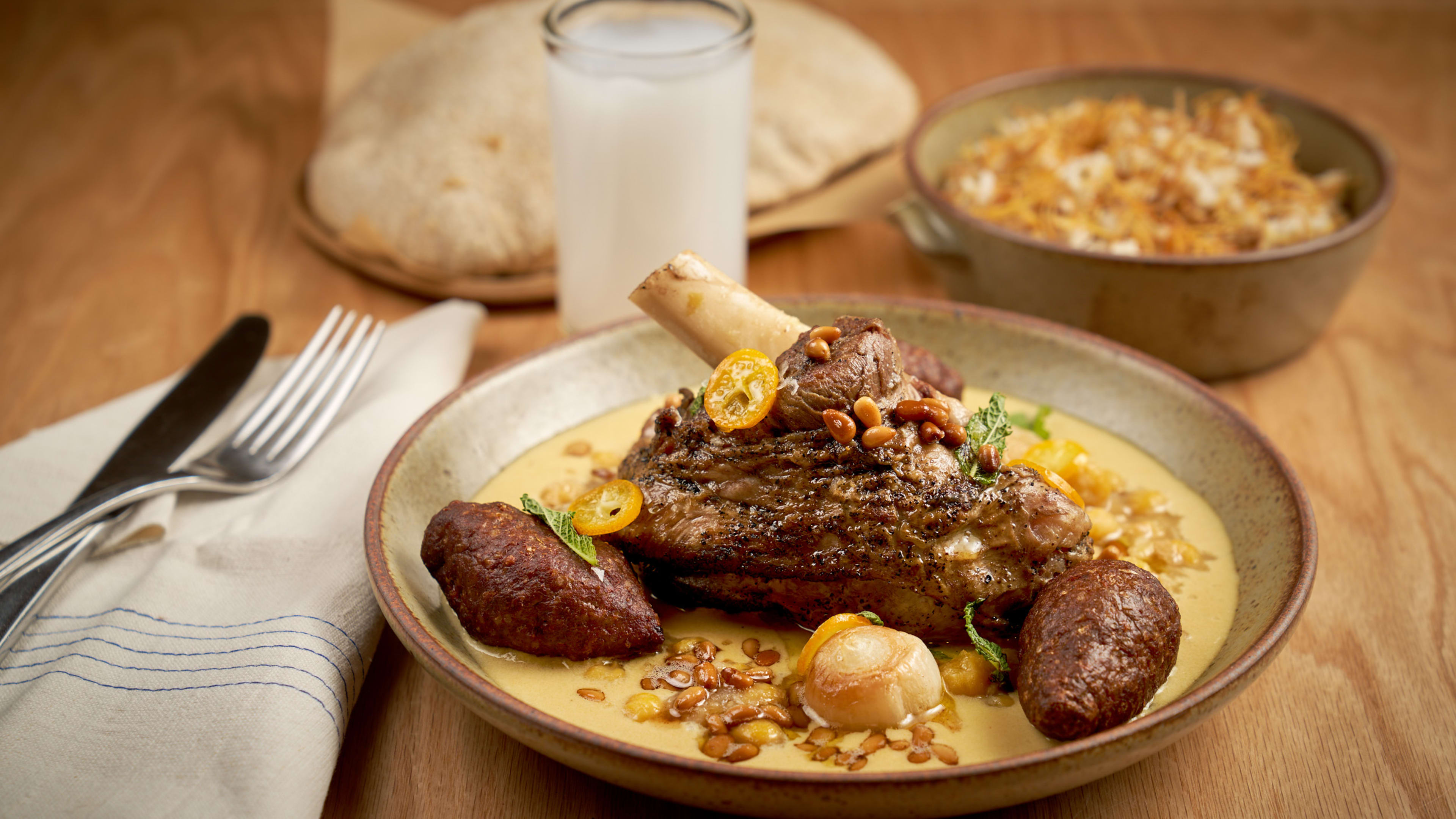 a roasted lamb shank with citrus and tahini