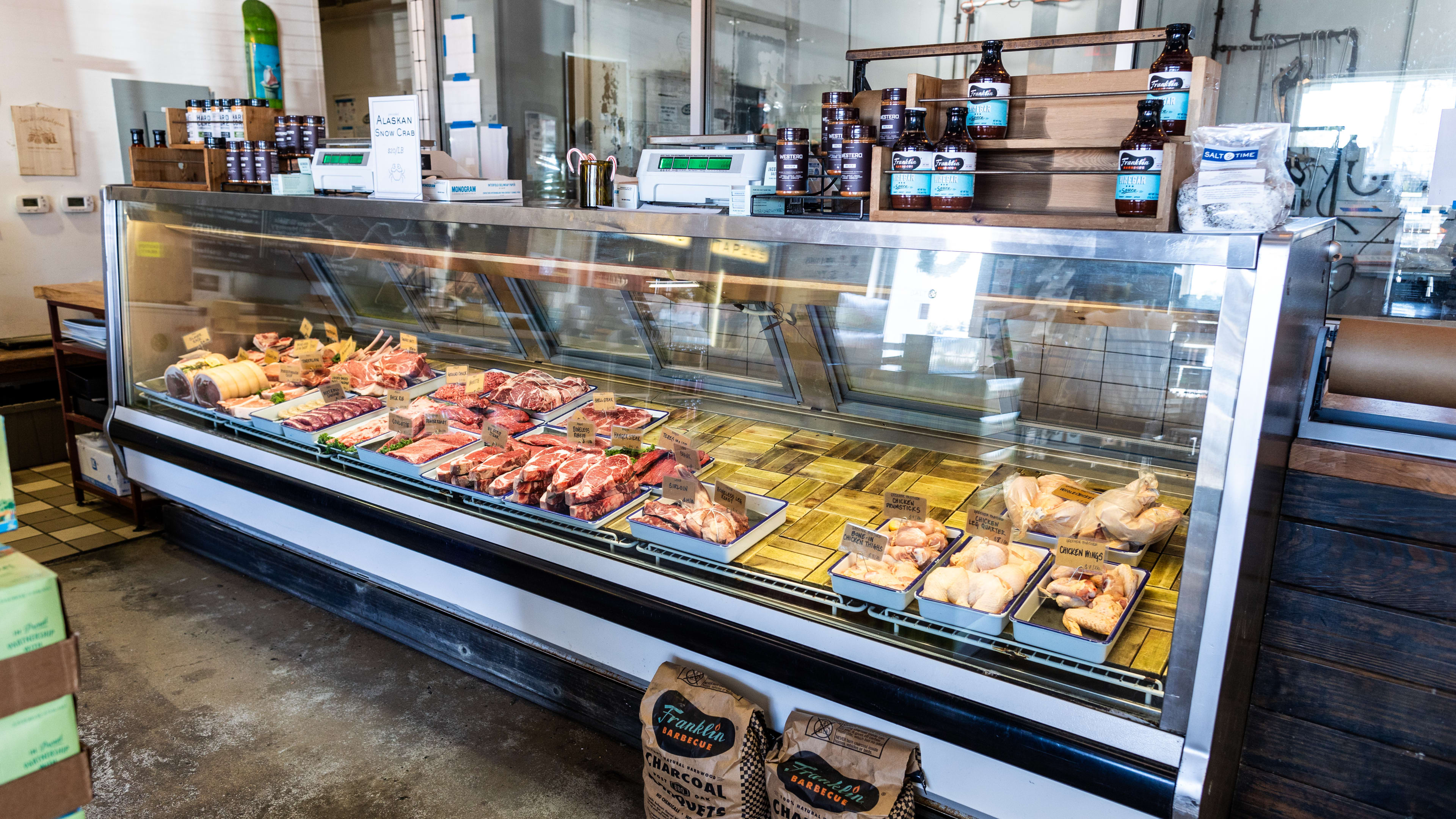 a butcher's display full of cuts of meat