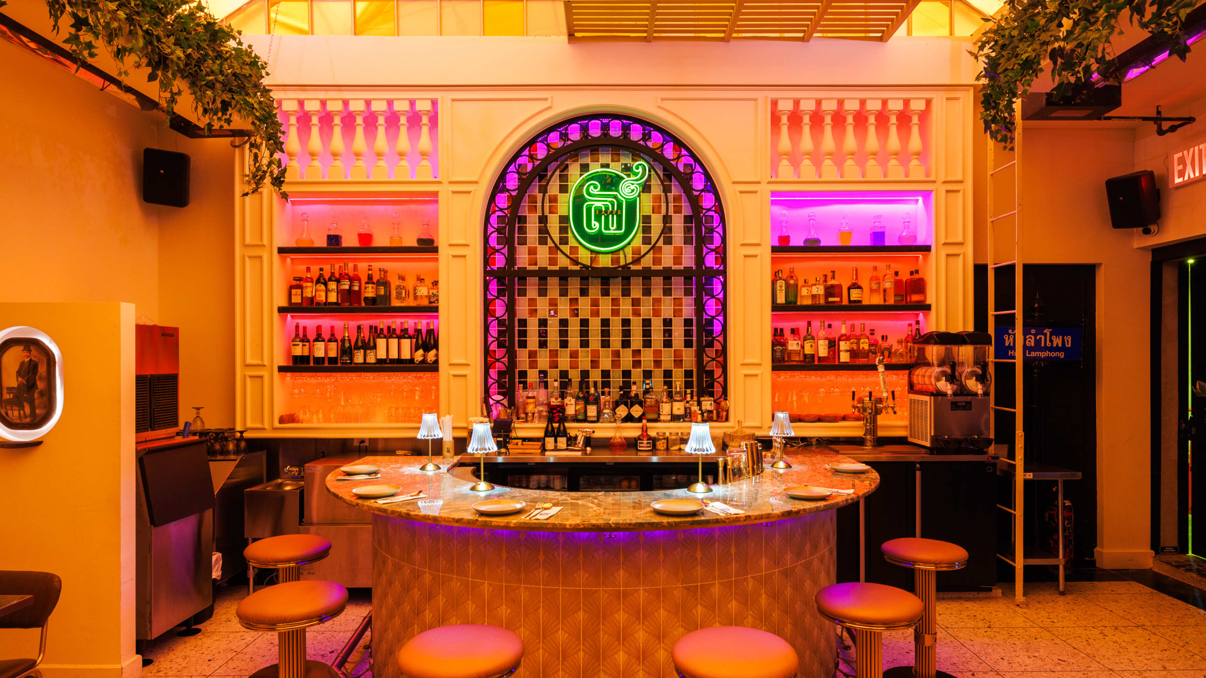 A U-shaped bar with neon lights around it.