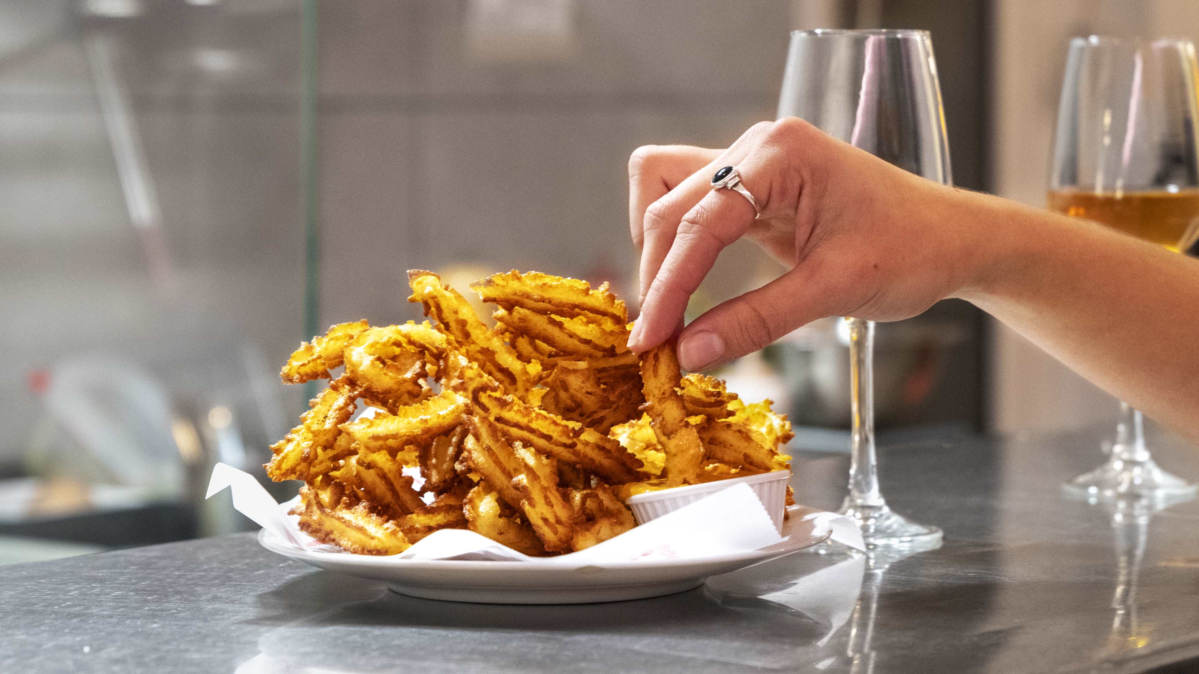 Churro-style patatas bravas and glasses of wine at Señora Dolores