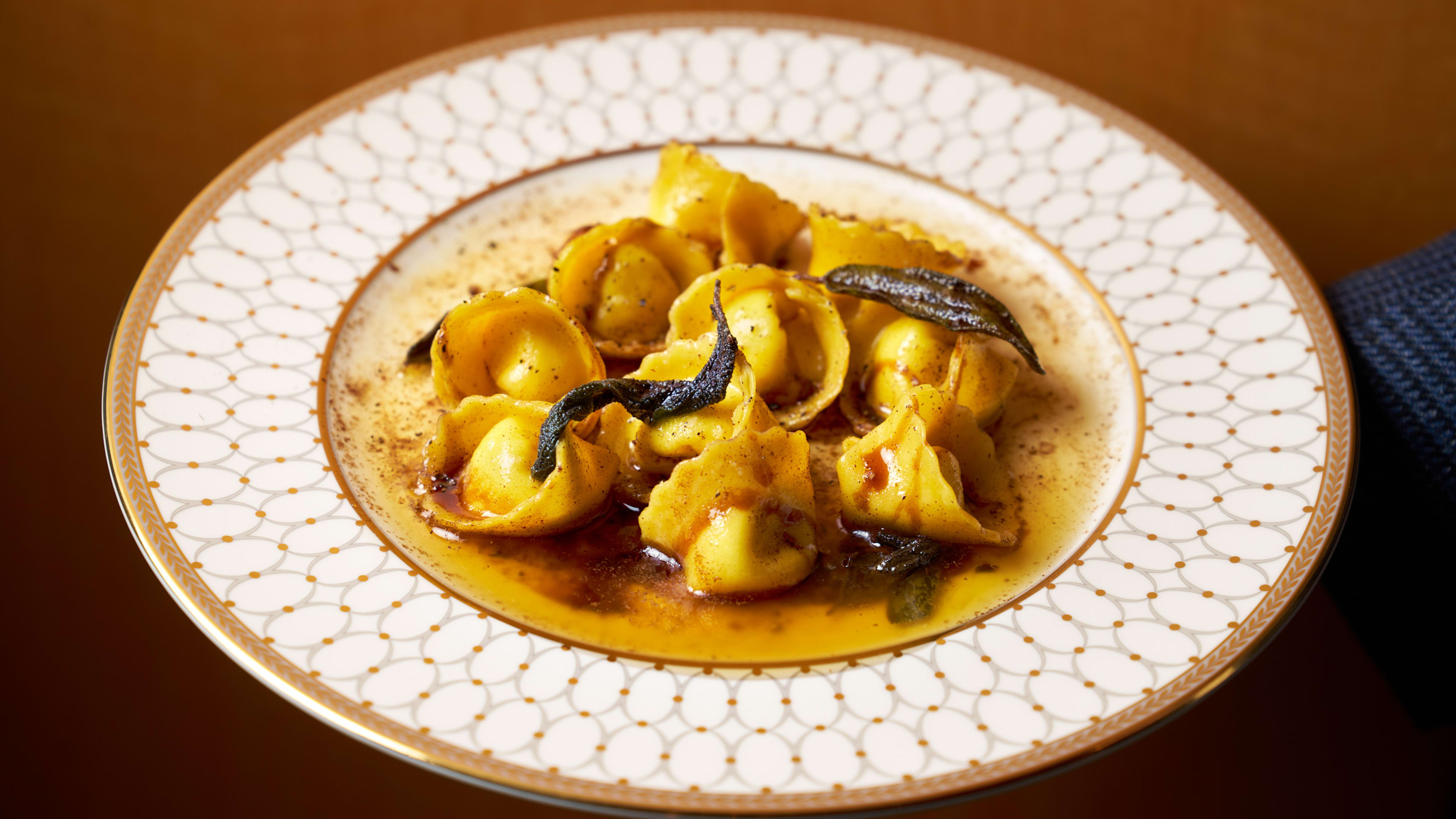 a bowl of tortellini in a brown butter sauce