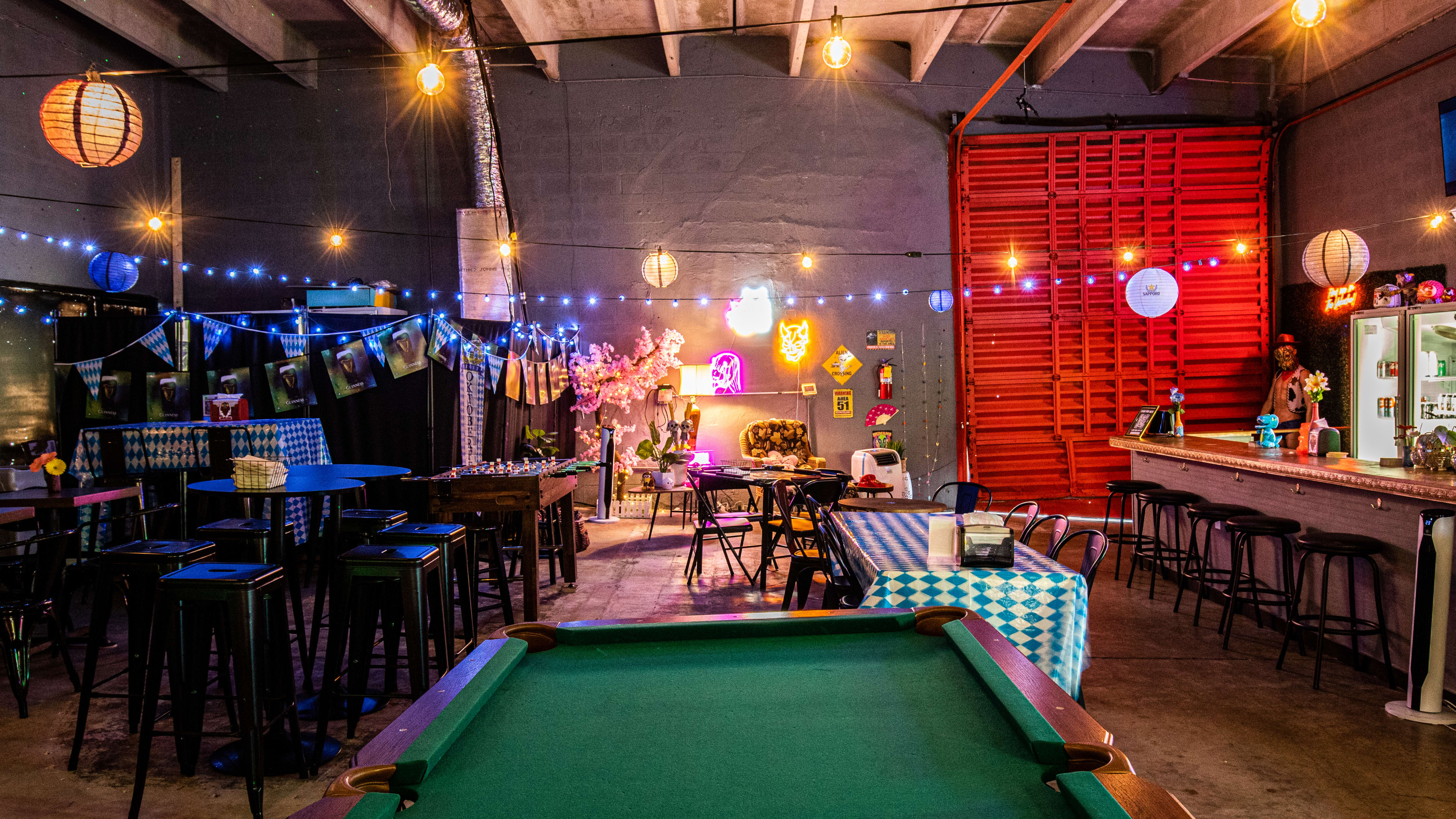 A pool table next to chairs.