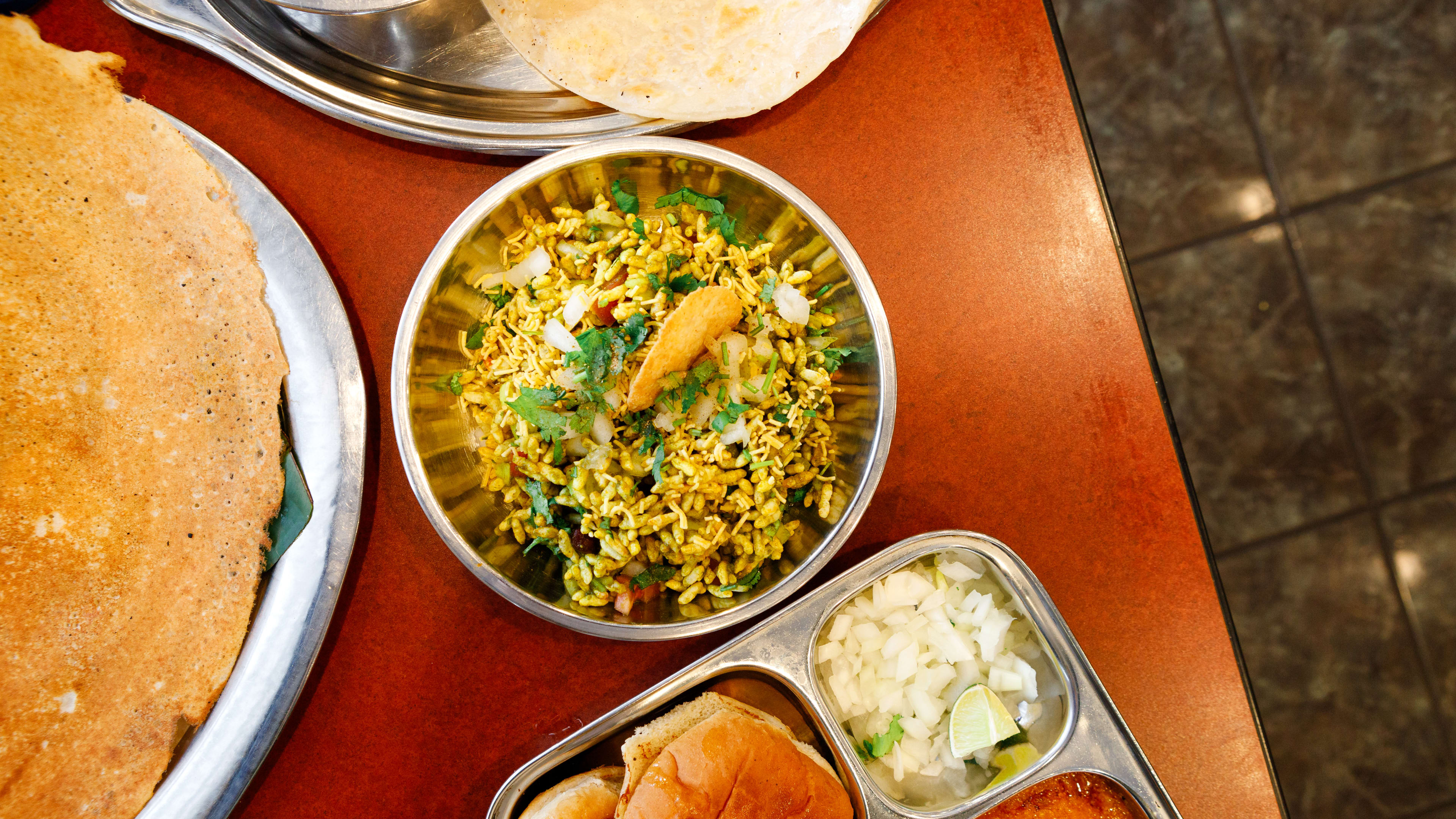 The bhel puri served in a metal bowl from Shri Balaji Bhavan.