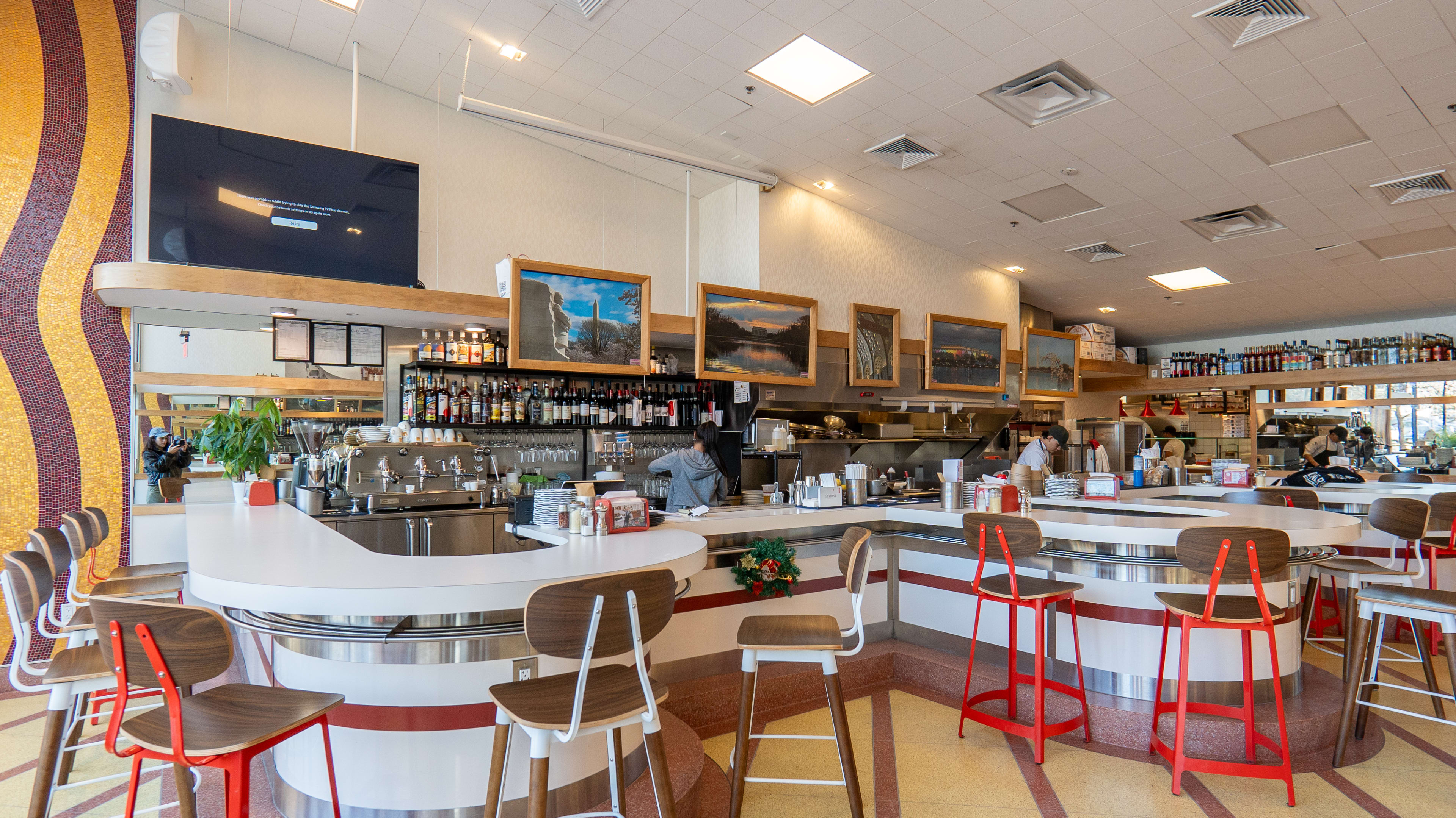 Curved bar with stools in restaurant interior