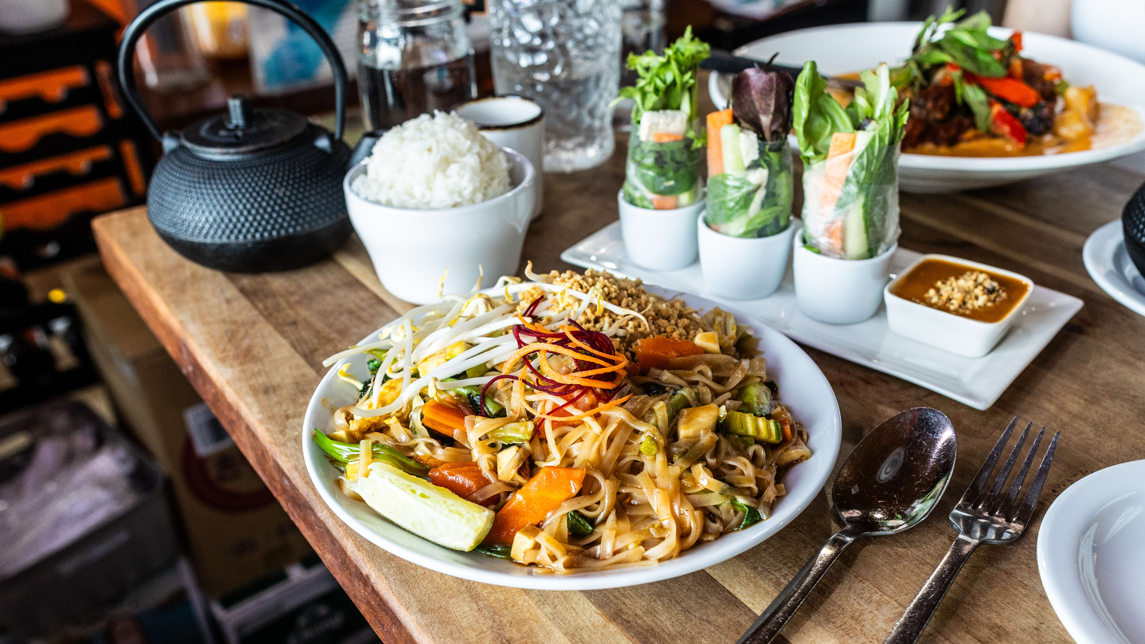 The pad thai vegetable surrounded by other various dishes from Super Thai.