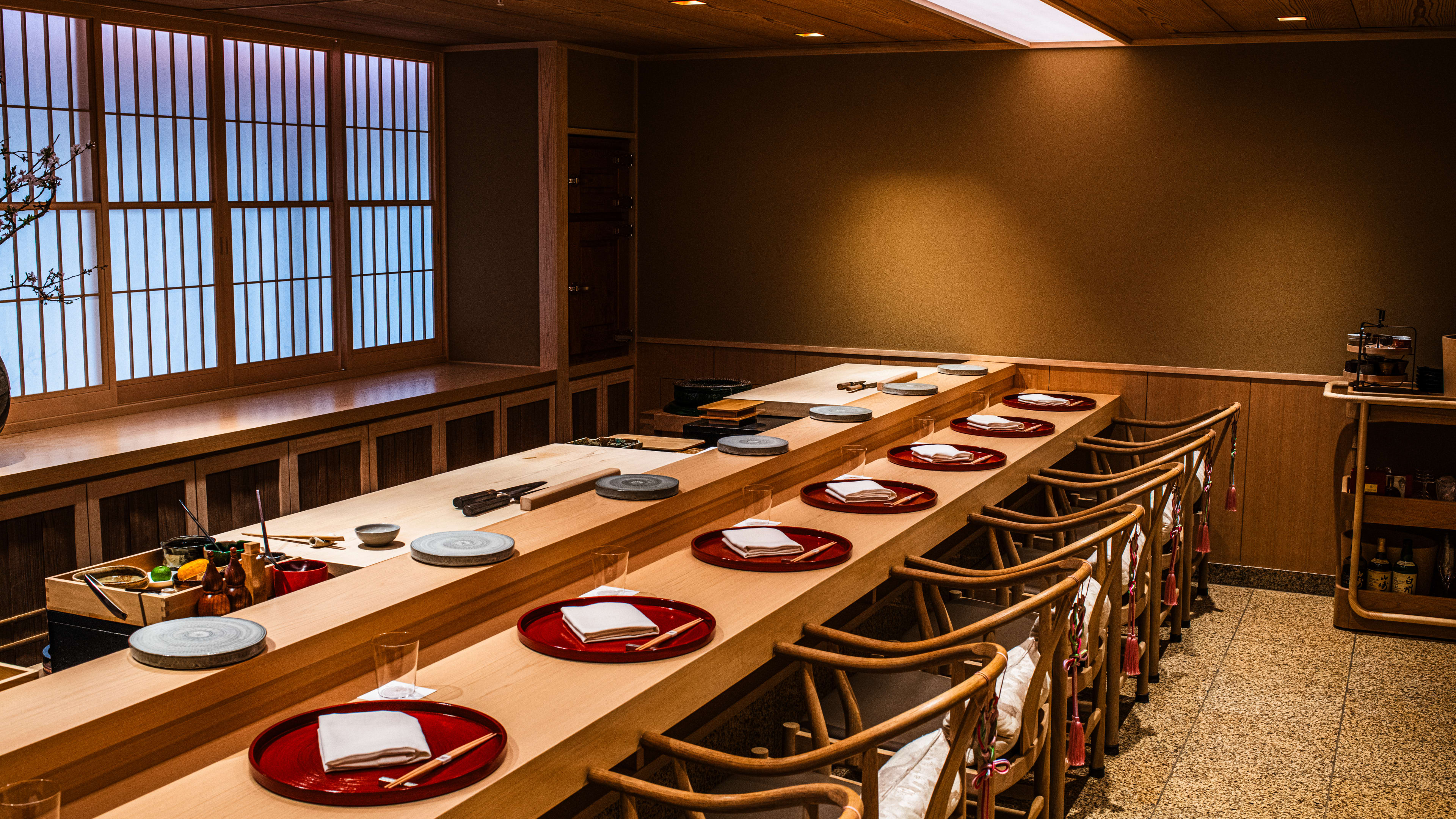 The traditional dining room at Sushi Kanesaka. There are 13 chairs at the counter.