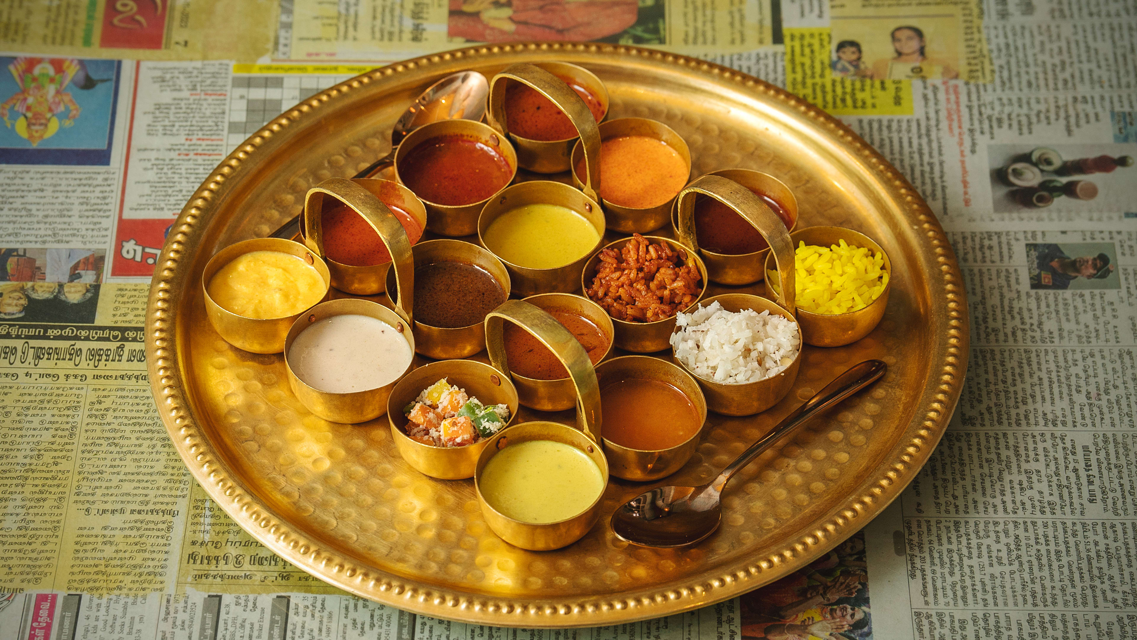 Sample platter of Tanjore Tiffin Room favorites plated on gold tray