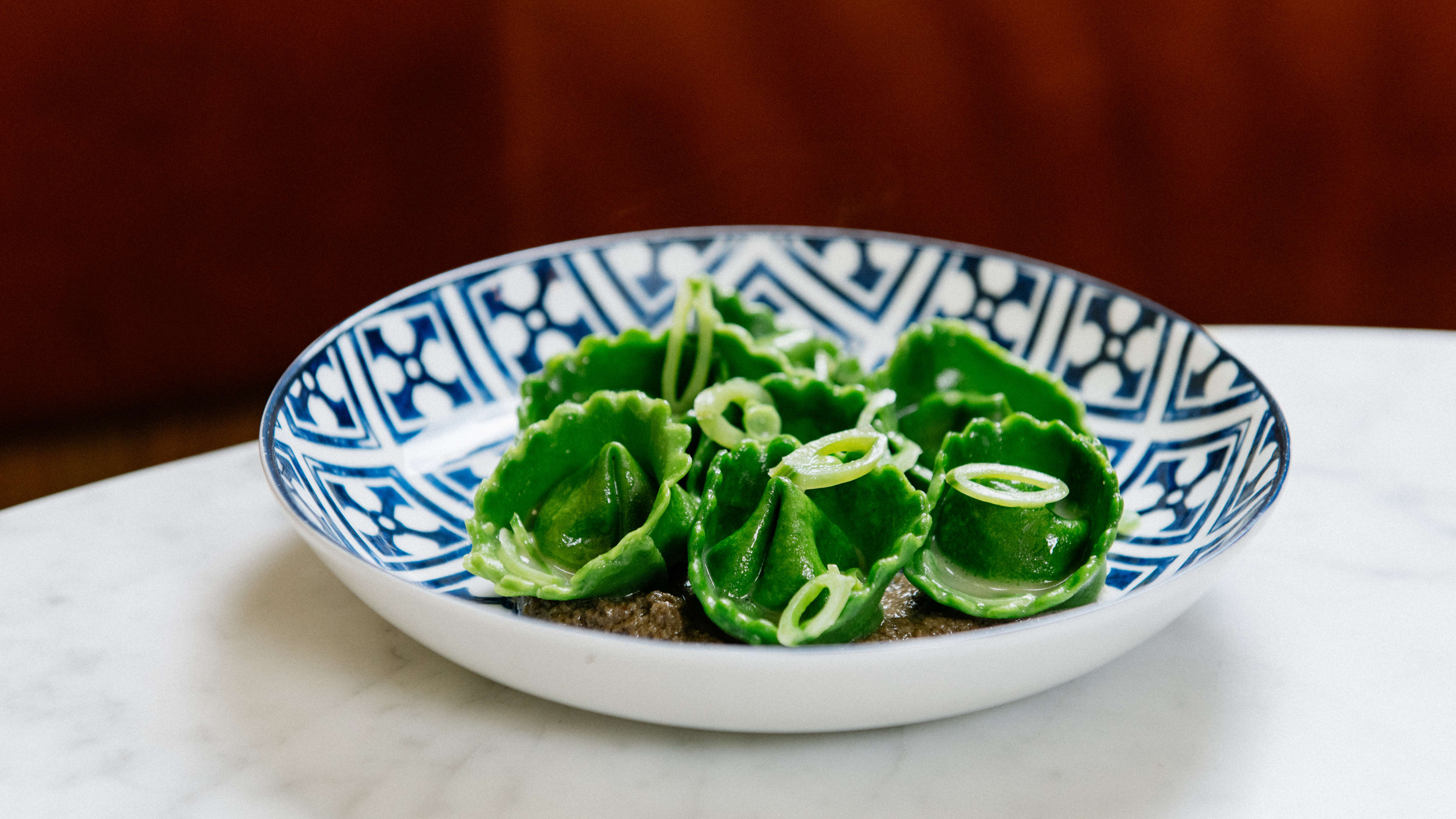 A bowl of bright green cappelletti.