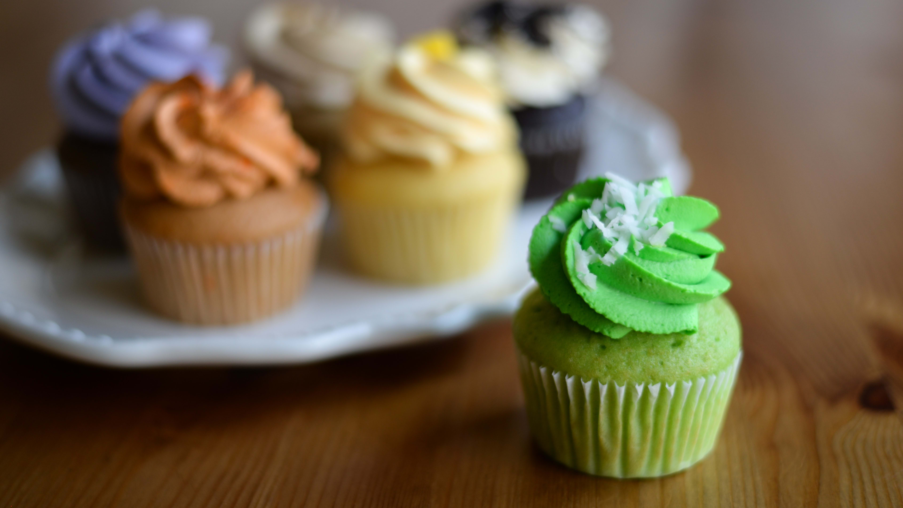 plate of colorful cupcakes