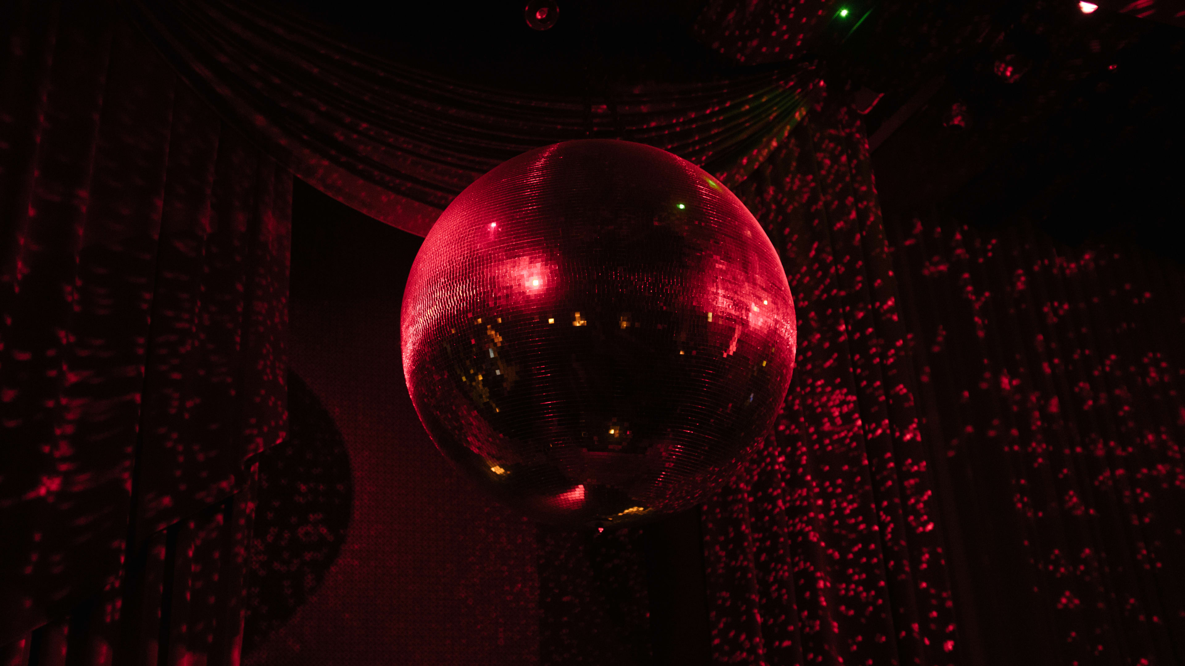 A disco ball in red light