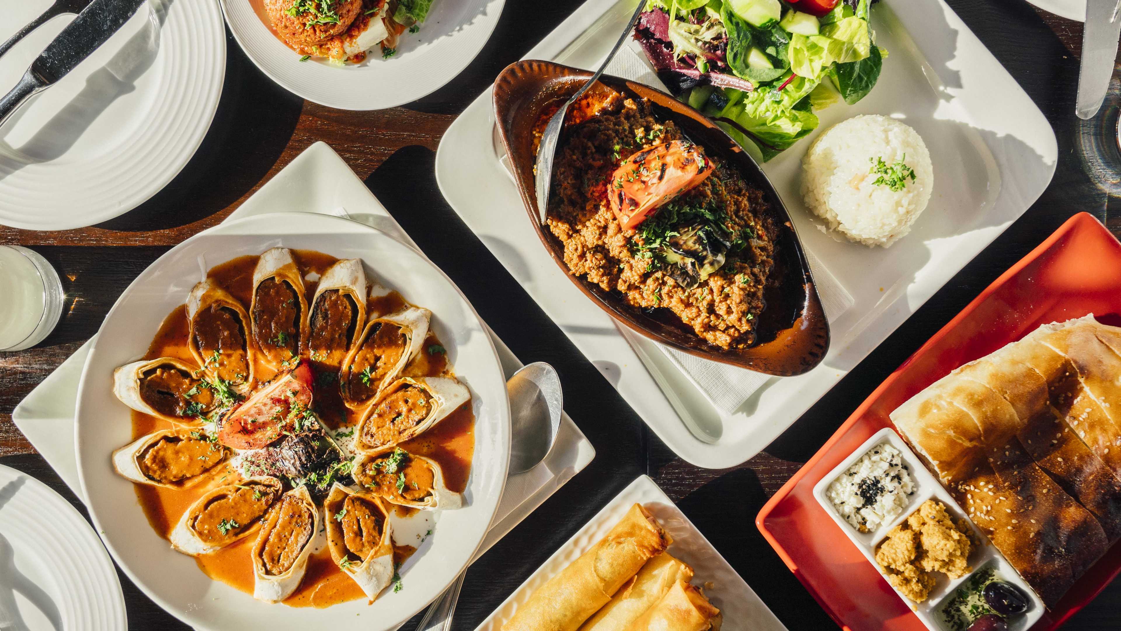 A spread of dishes and house bread at Tuba