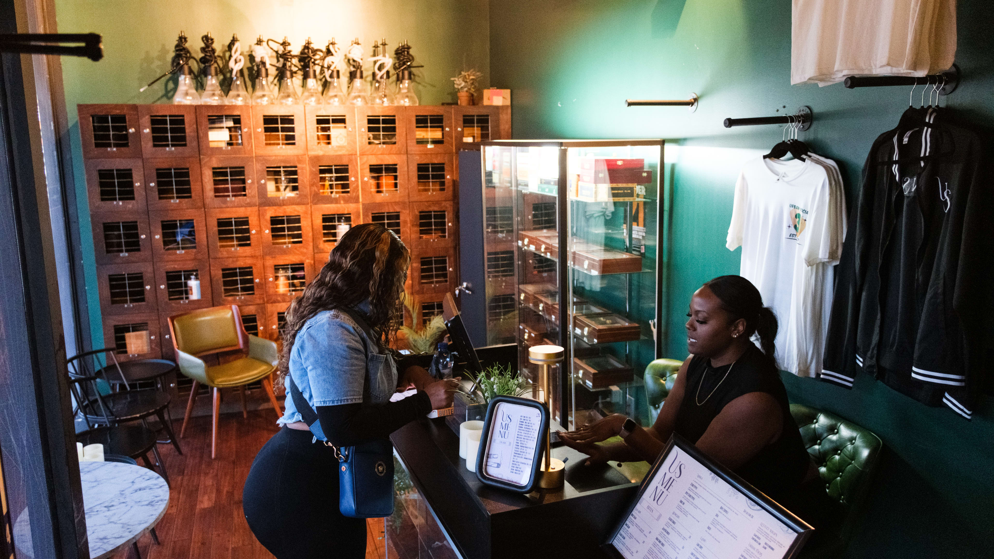 A person selects the type of hookah they want at the order counter at Urban Smoke.