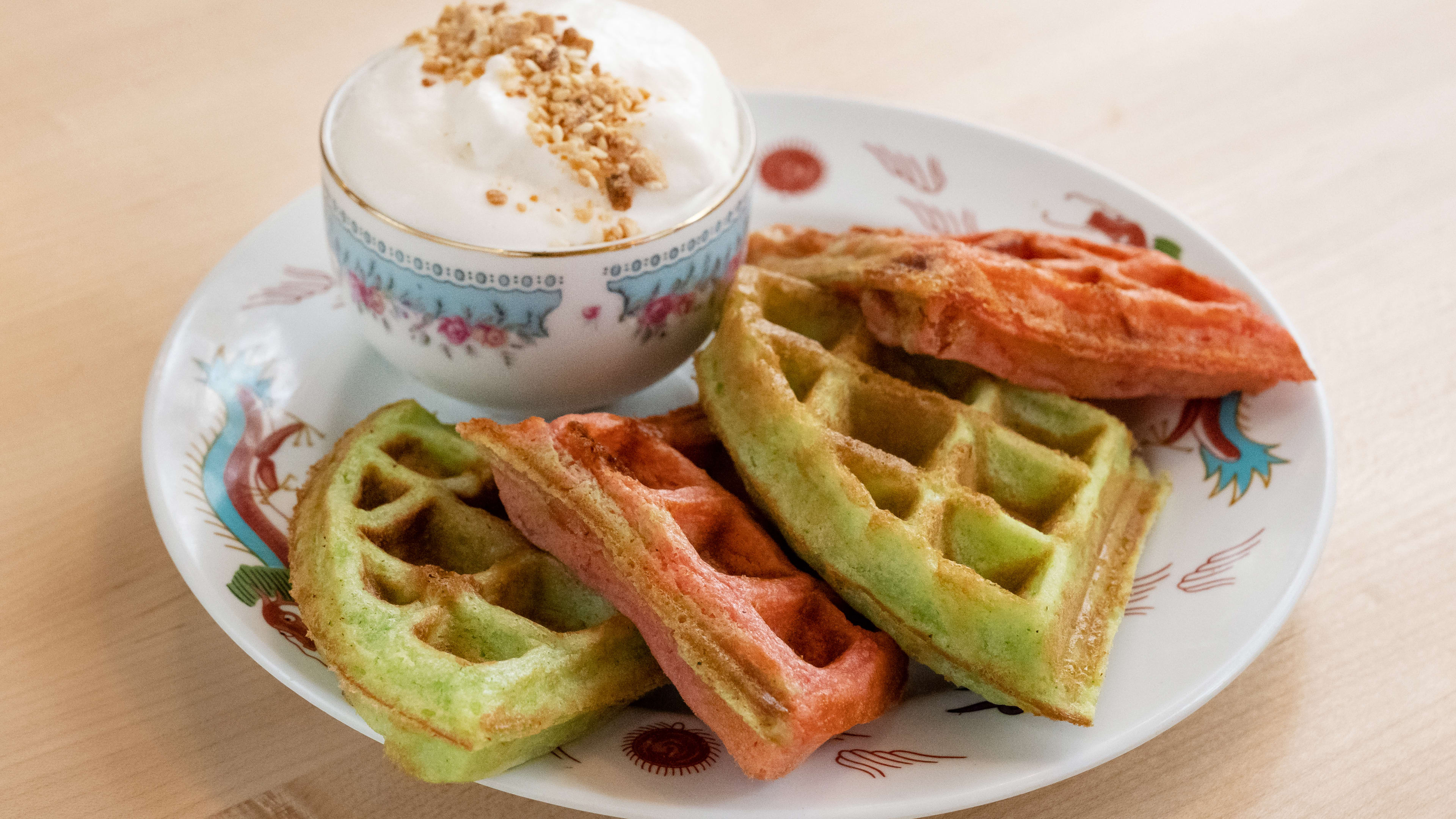 Multicolored waffle wedges on a decorative plate.