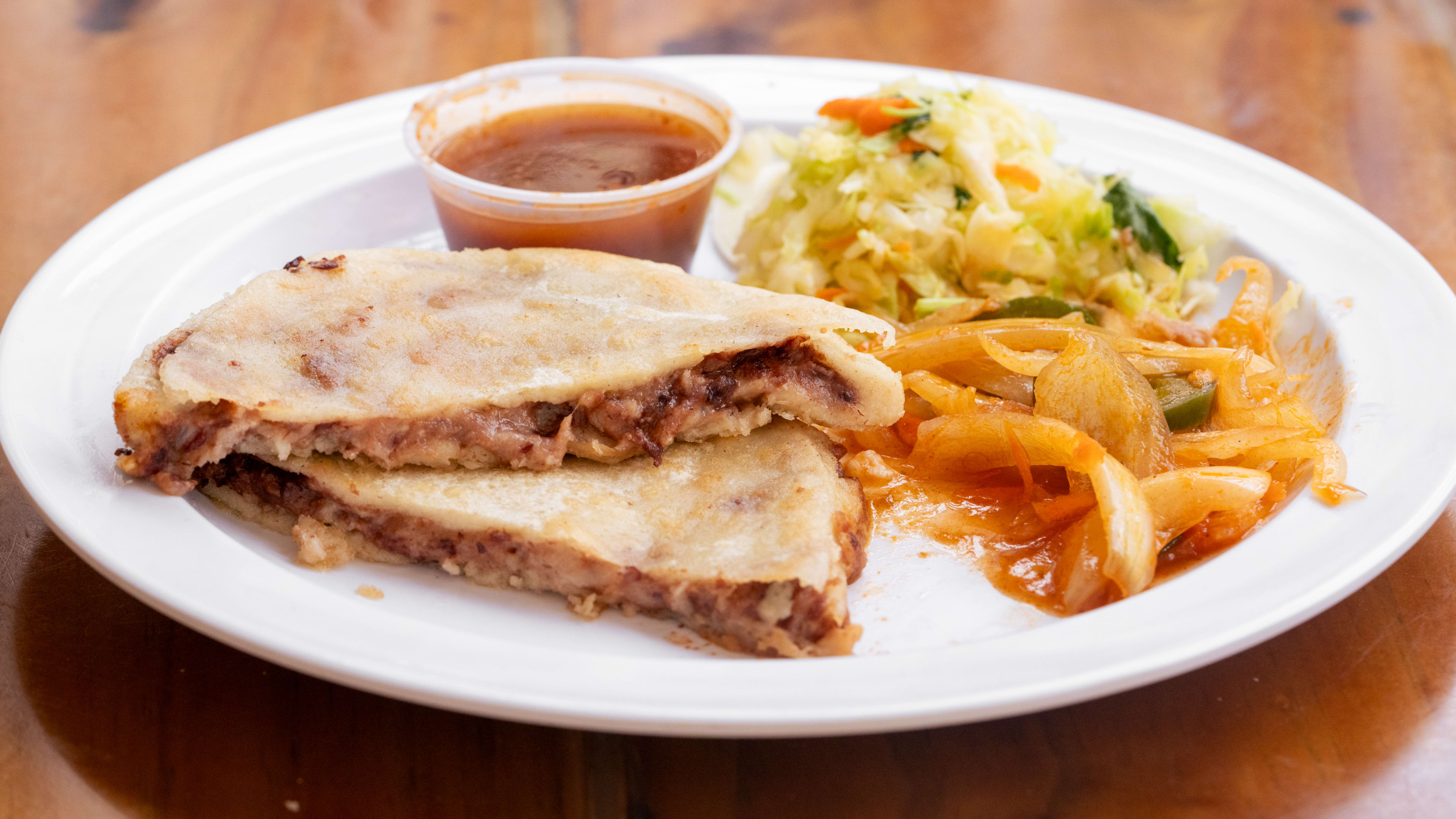 Pupusa with bean, cheese, and chicharron filling.