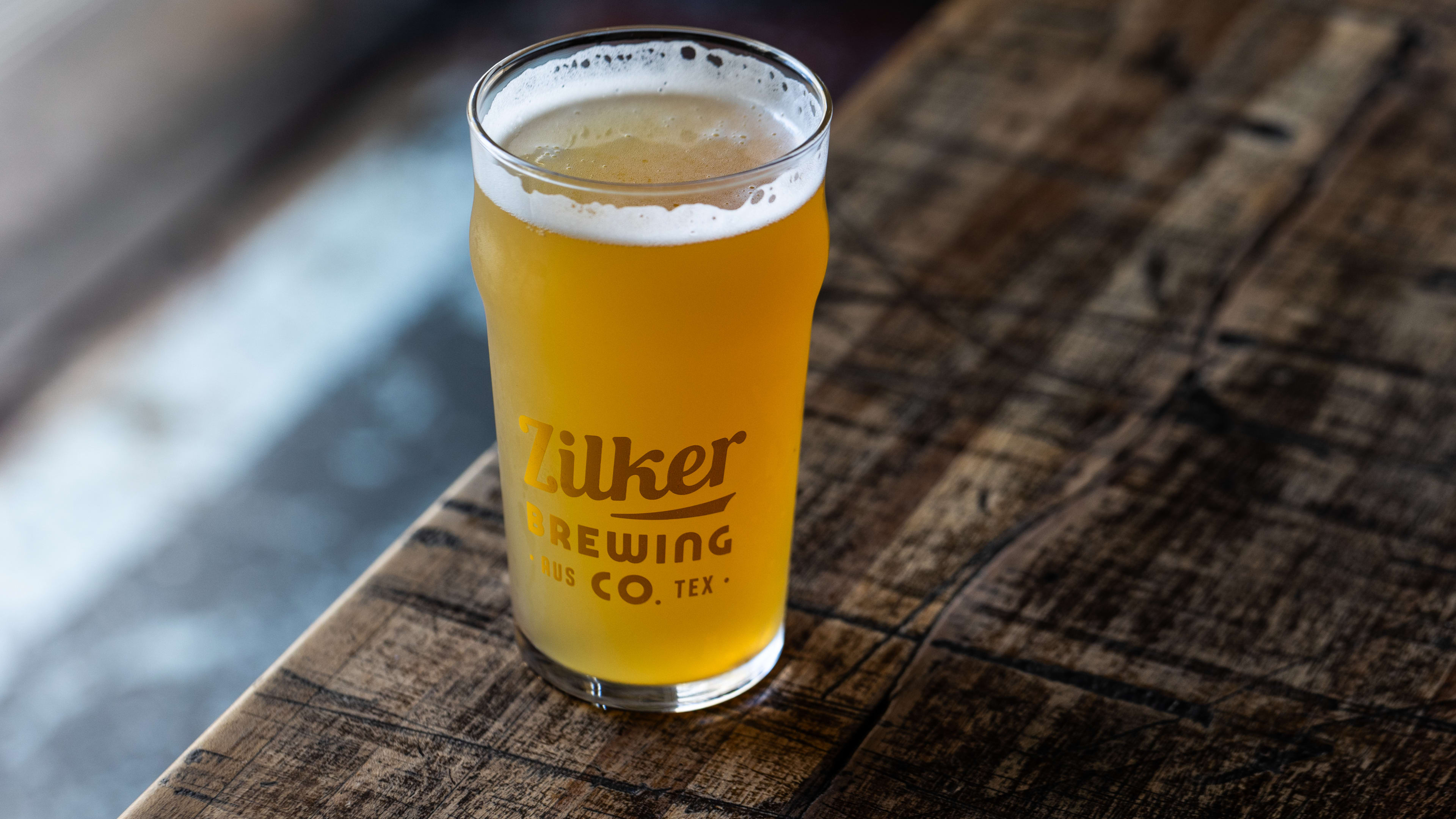 The Heavenly Daze from Zilker Brewing on a wooden table.