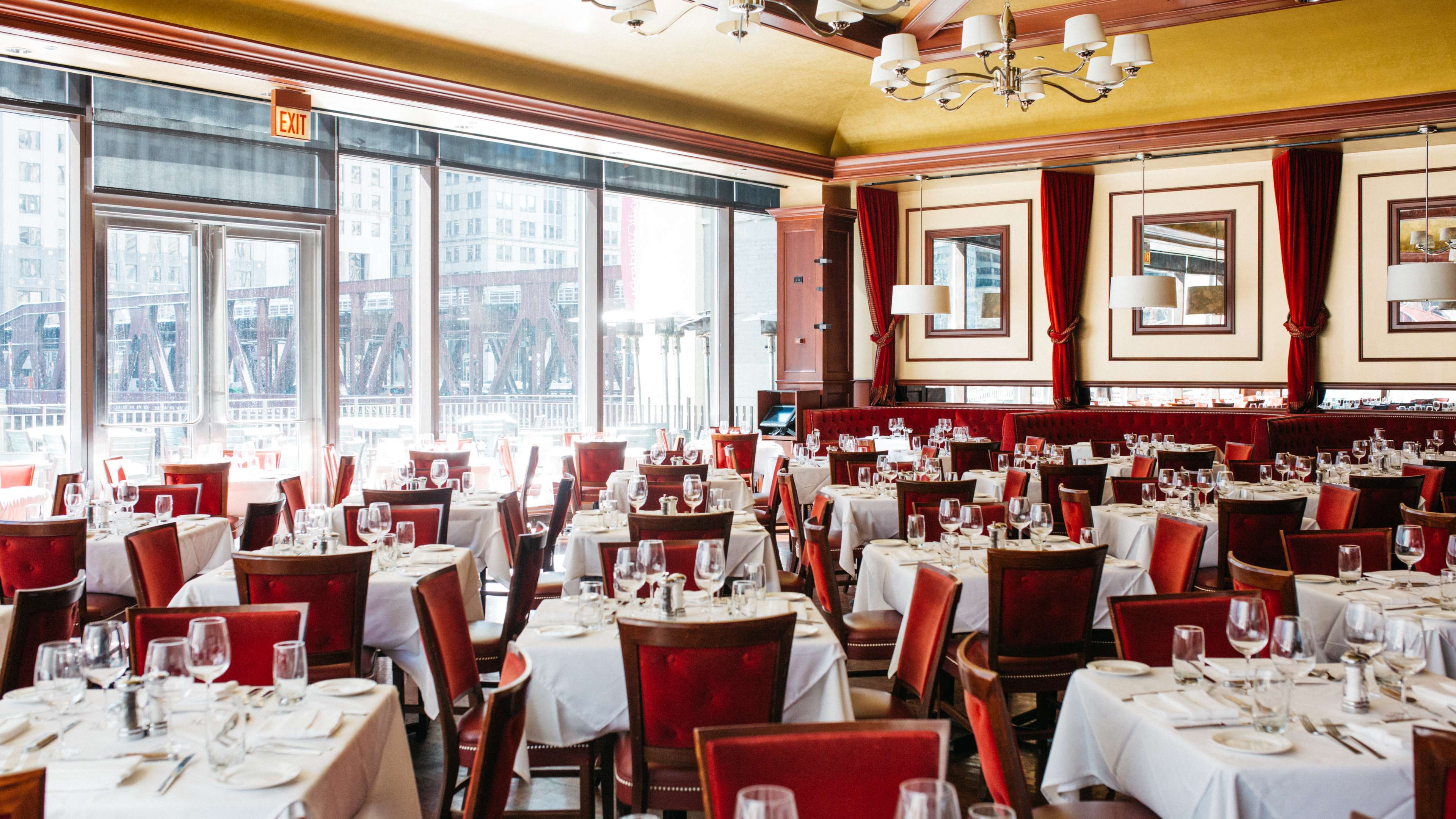 The dining room with red velvet booths and curtains at Chicago Cut.