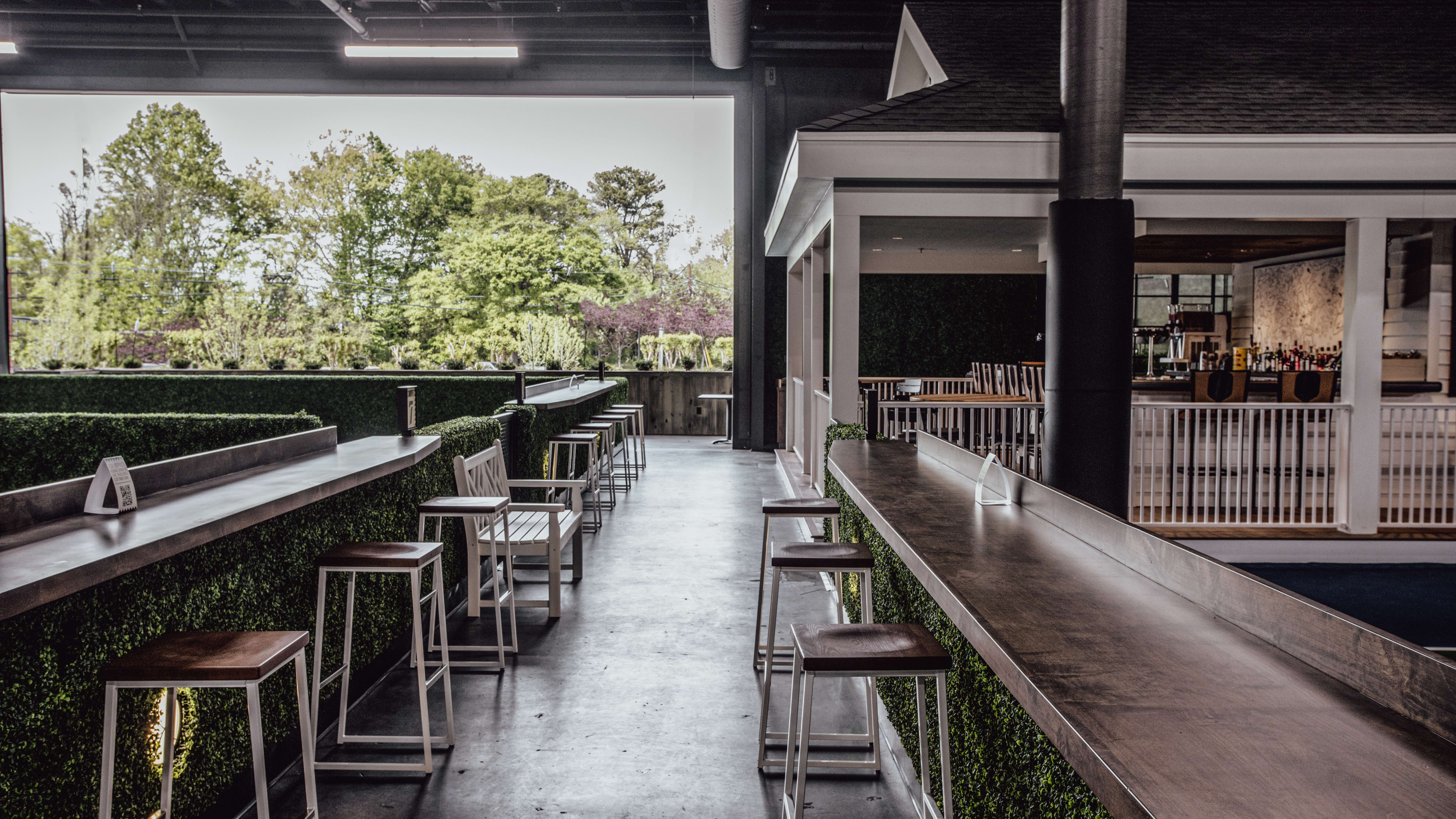 dining area with pickleball courts, bar, and outdoor patio