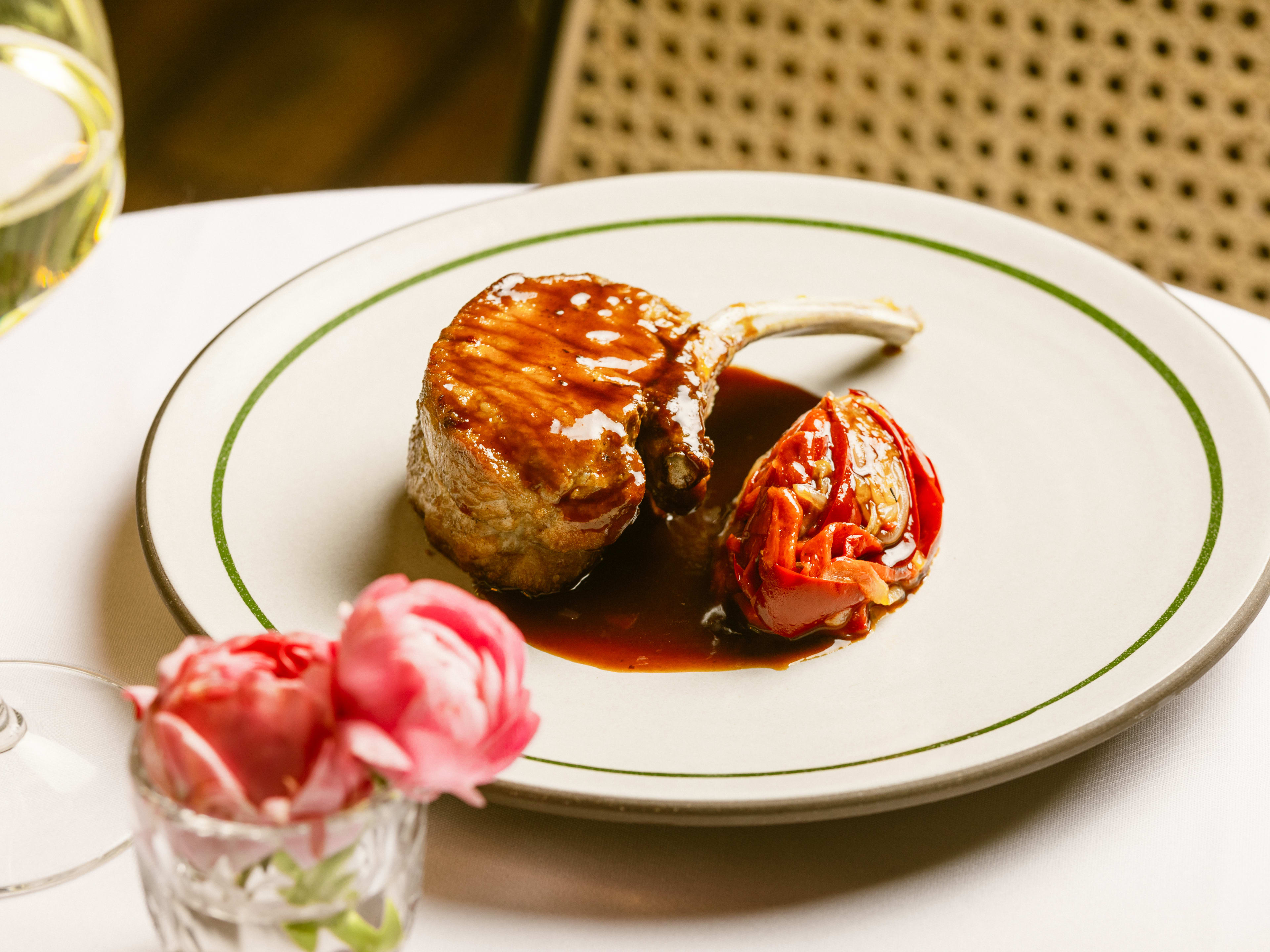 Pork chop on a plate at Tucci.