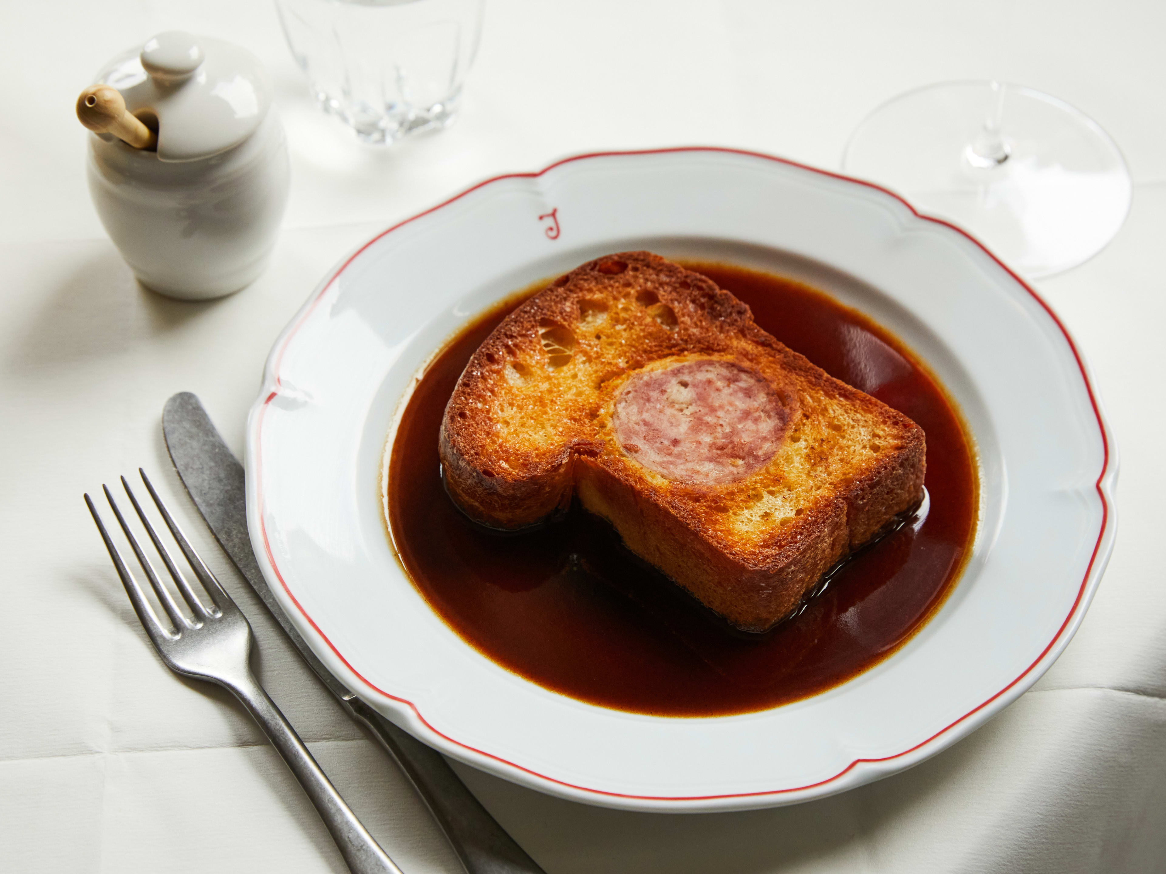 A savoury brioche with sausage in it sitting in gravy from Josephine.