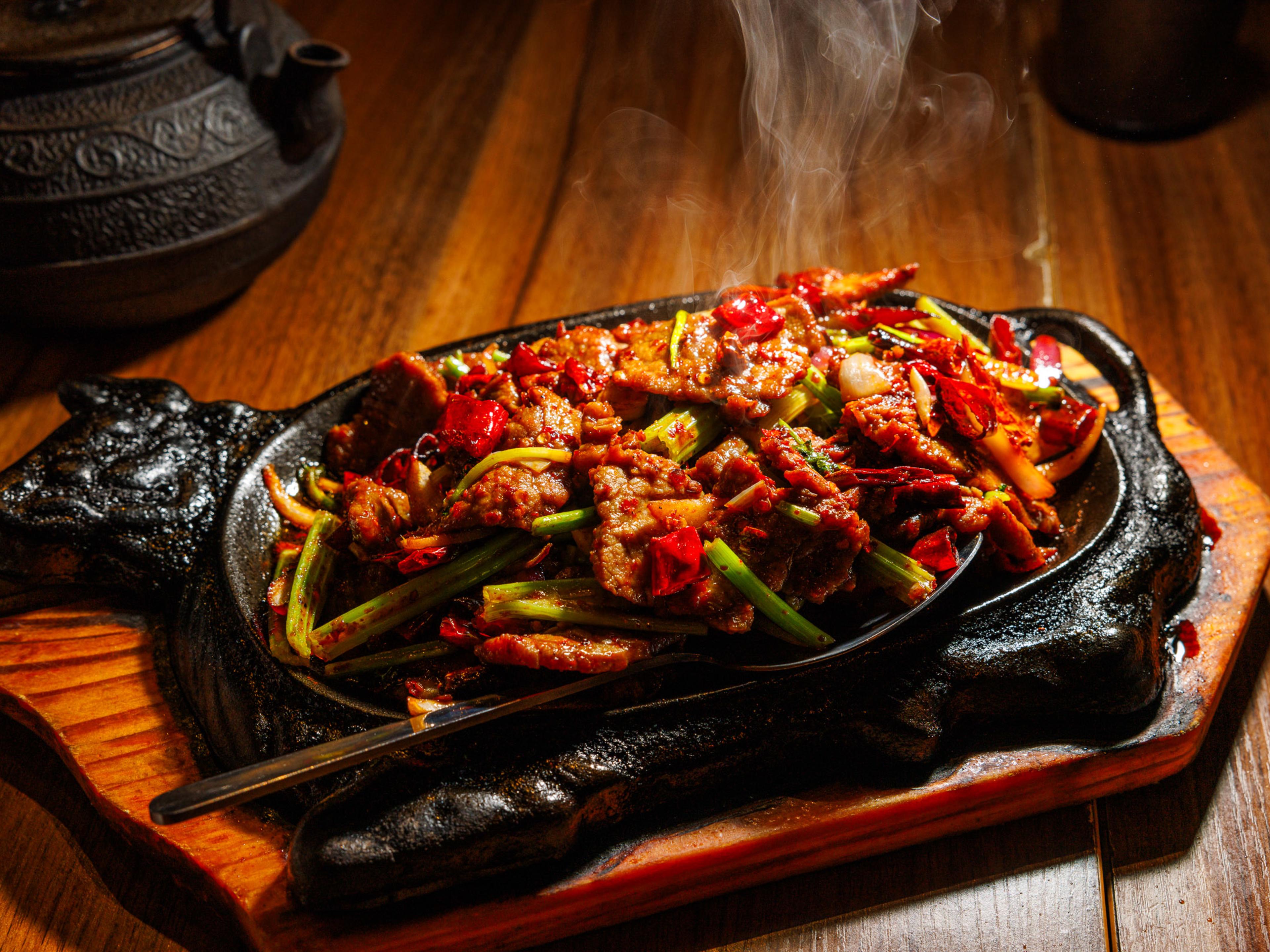 Sizzling cumin beef on a platter.