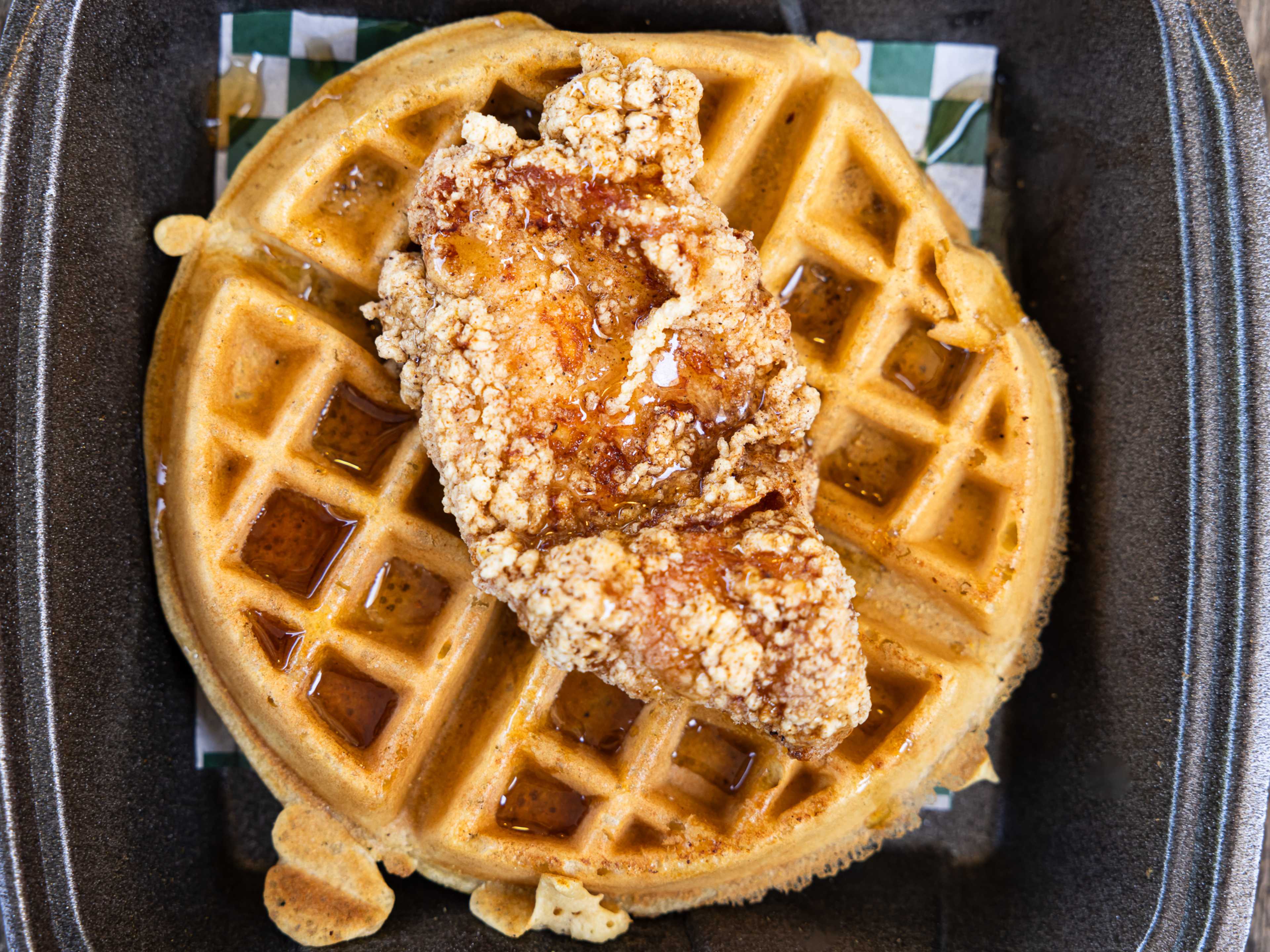 Fried chicken on top of a huge waffle.