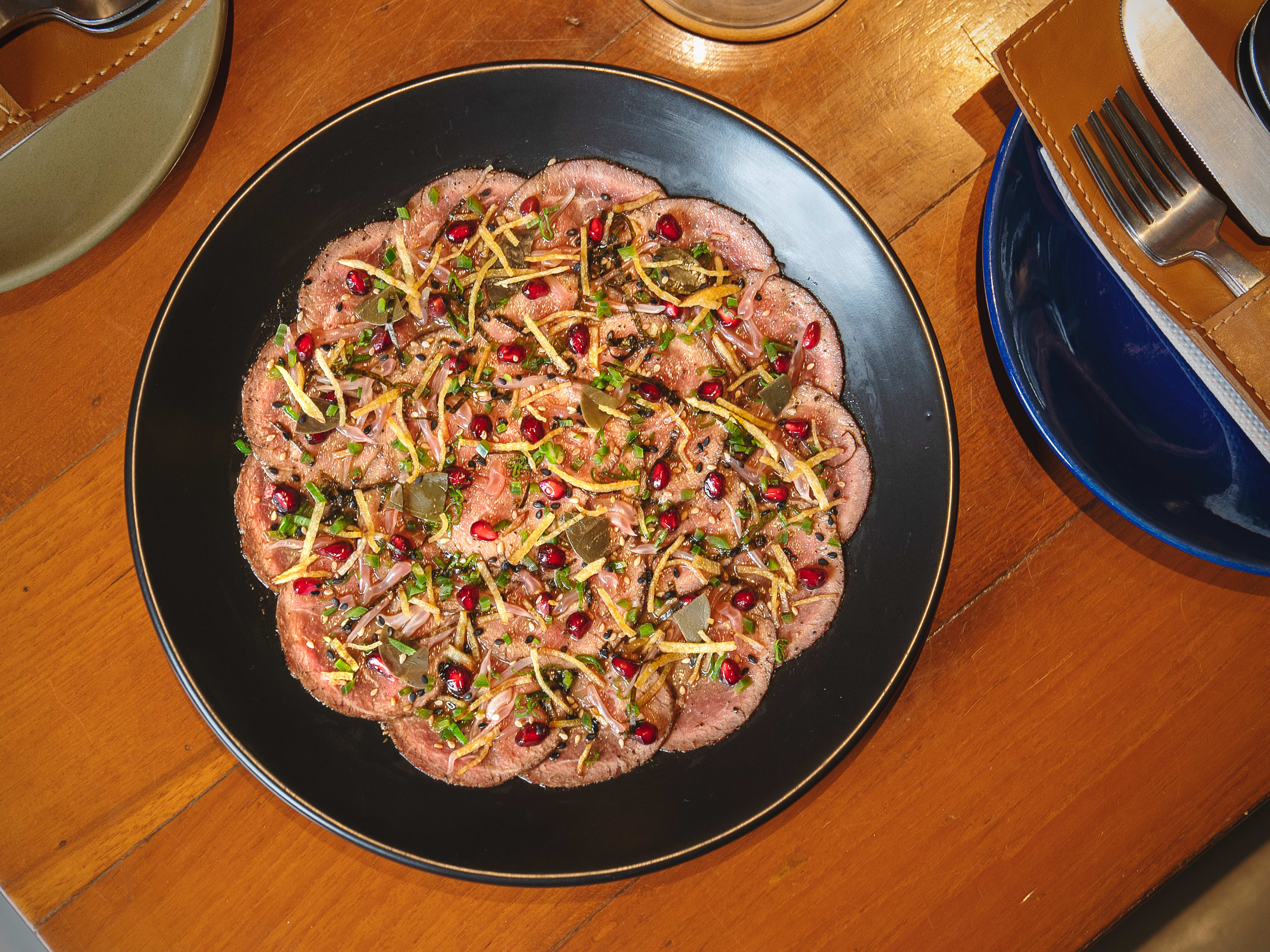 Kameena carpaccio topped with pomegranate seeds at Bandra Born