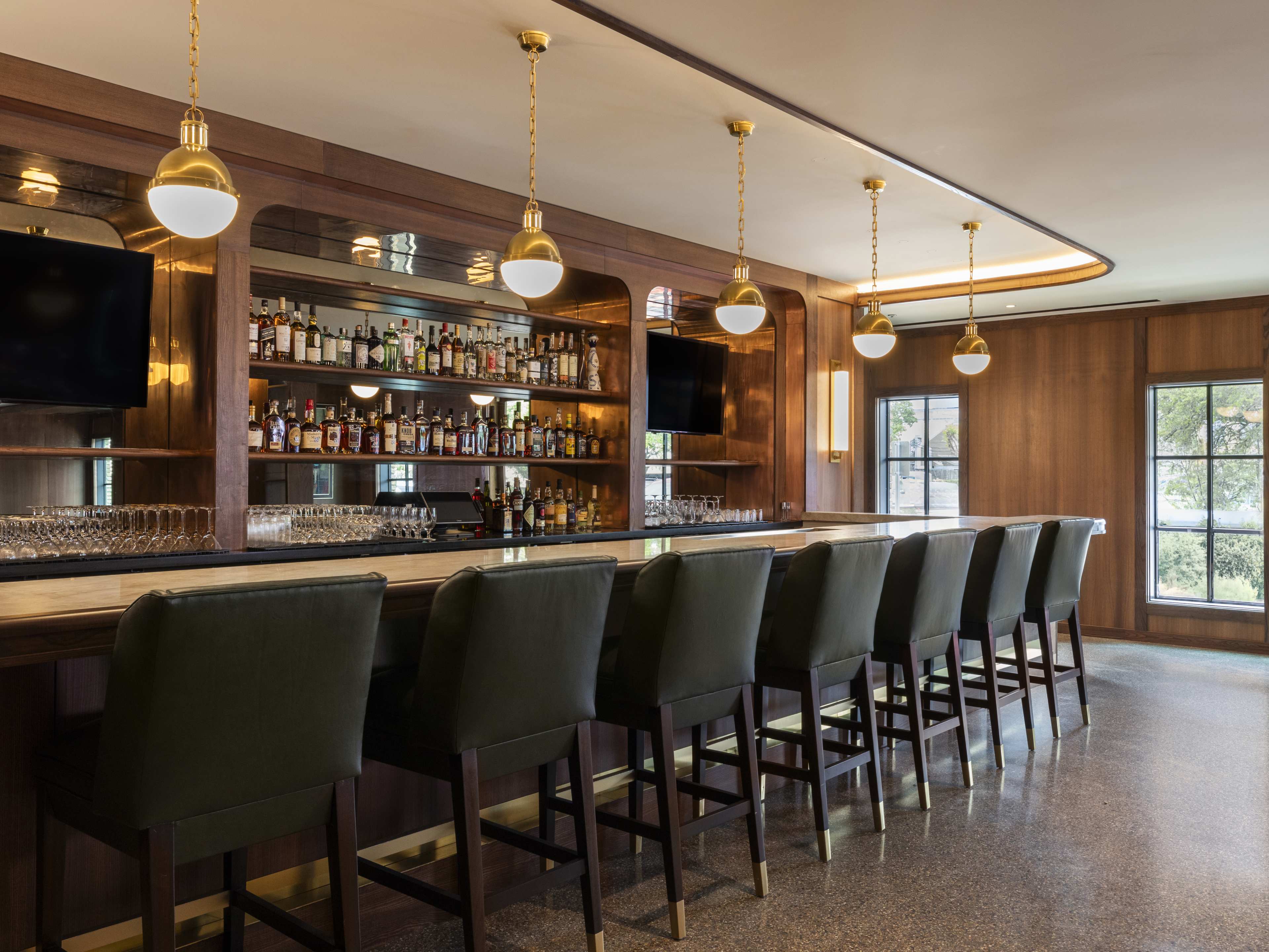 dark wood bar with vintage gold pendant lights at Bar Bludorn