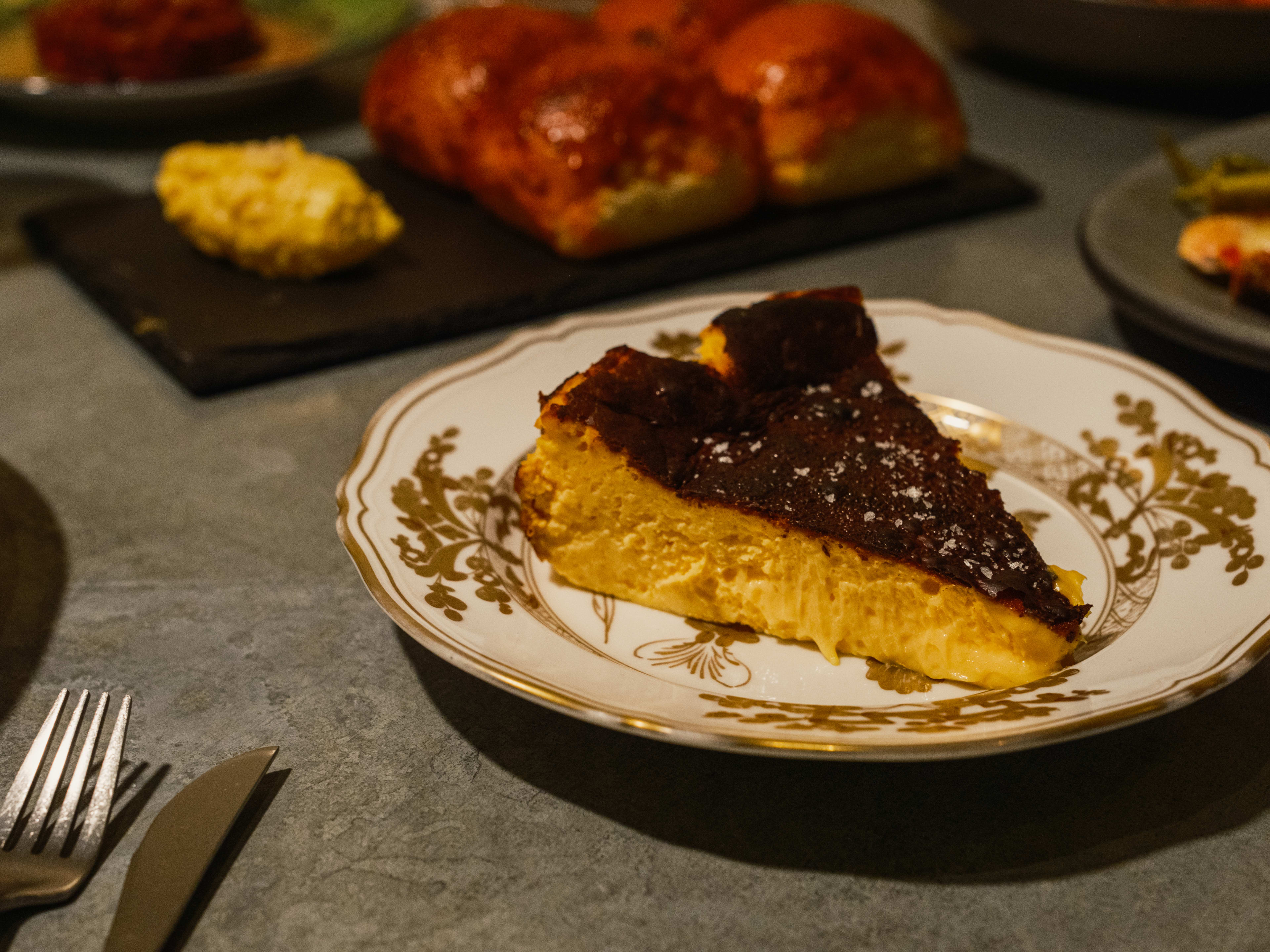 gold filigree plate at Baso with a thick slice of yellow tarta de queso