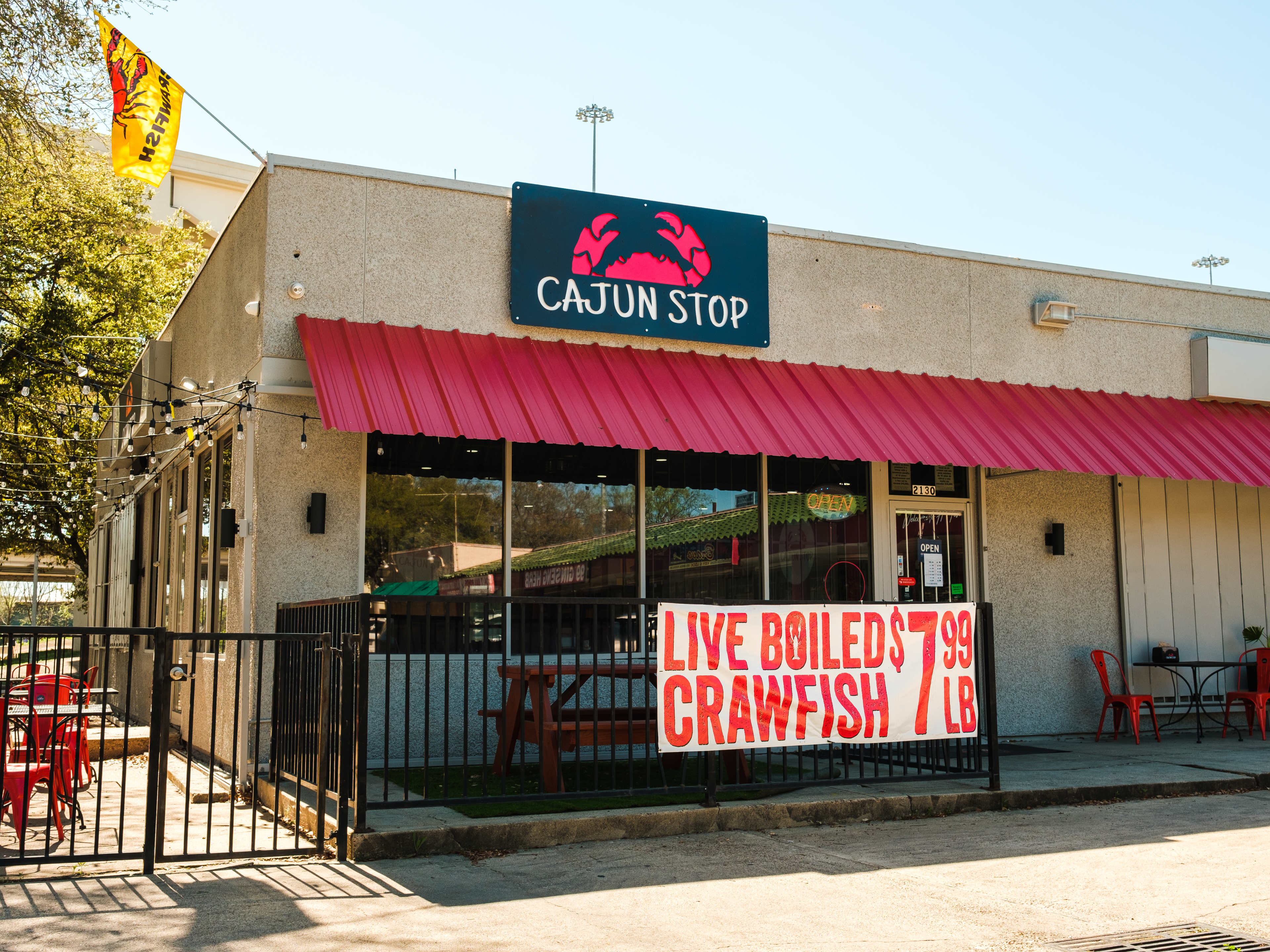 exterior of The Cajun Stop with a red awning, and sign reading Live Boiled Crawfish