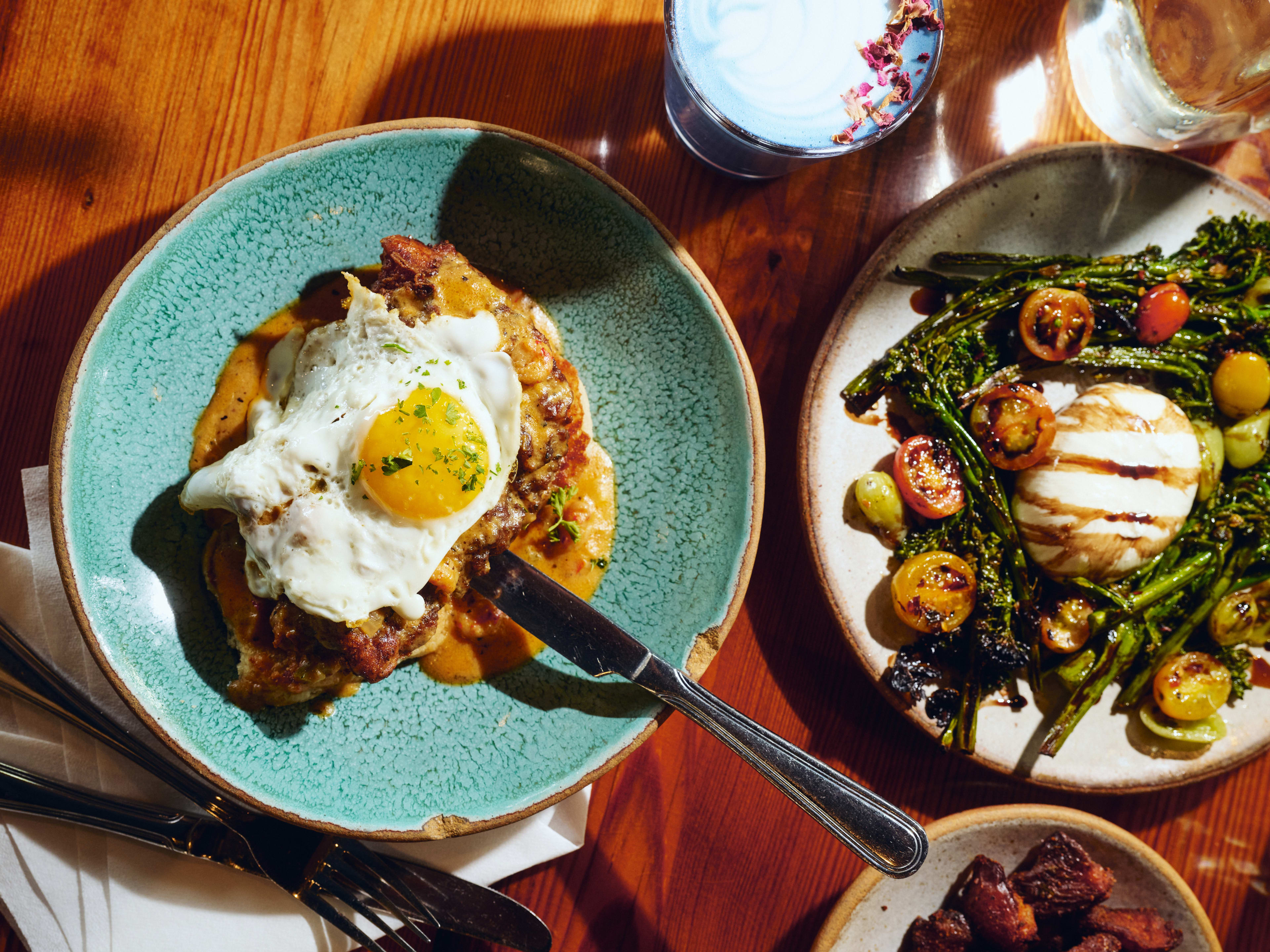 Spread of breakfast dishes and coffee drinks at Bearcat Cafe