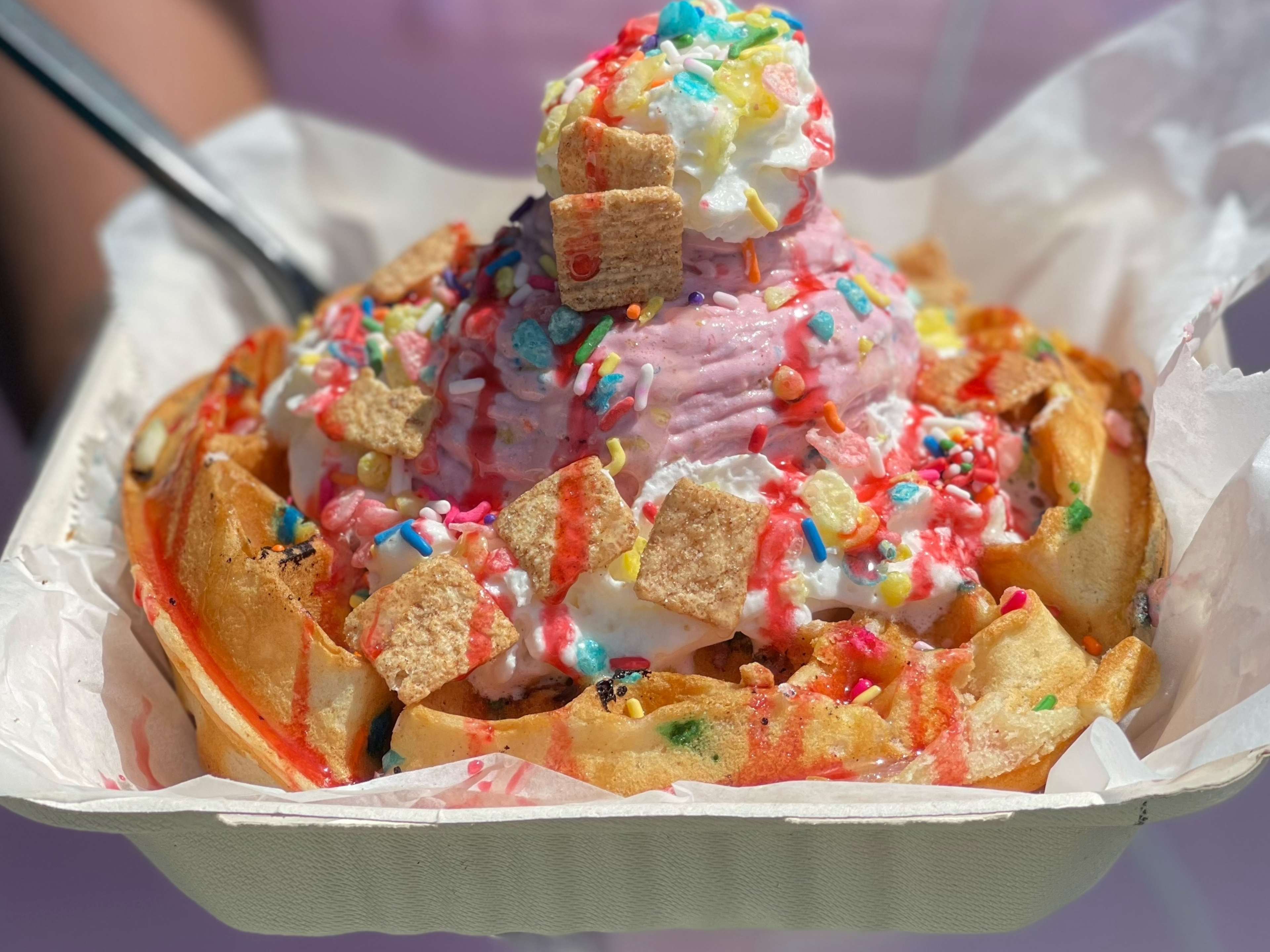 Cereal covering ice cream with sprinkles.