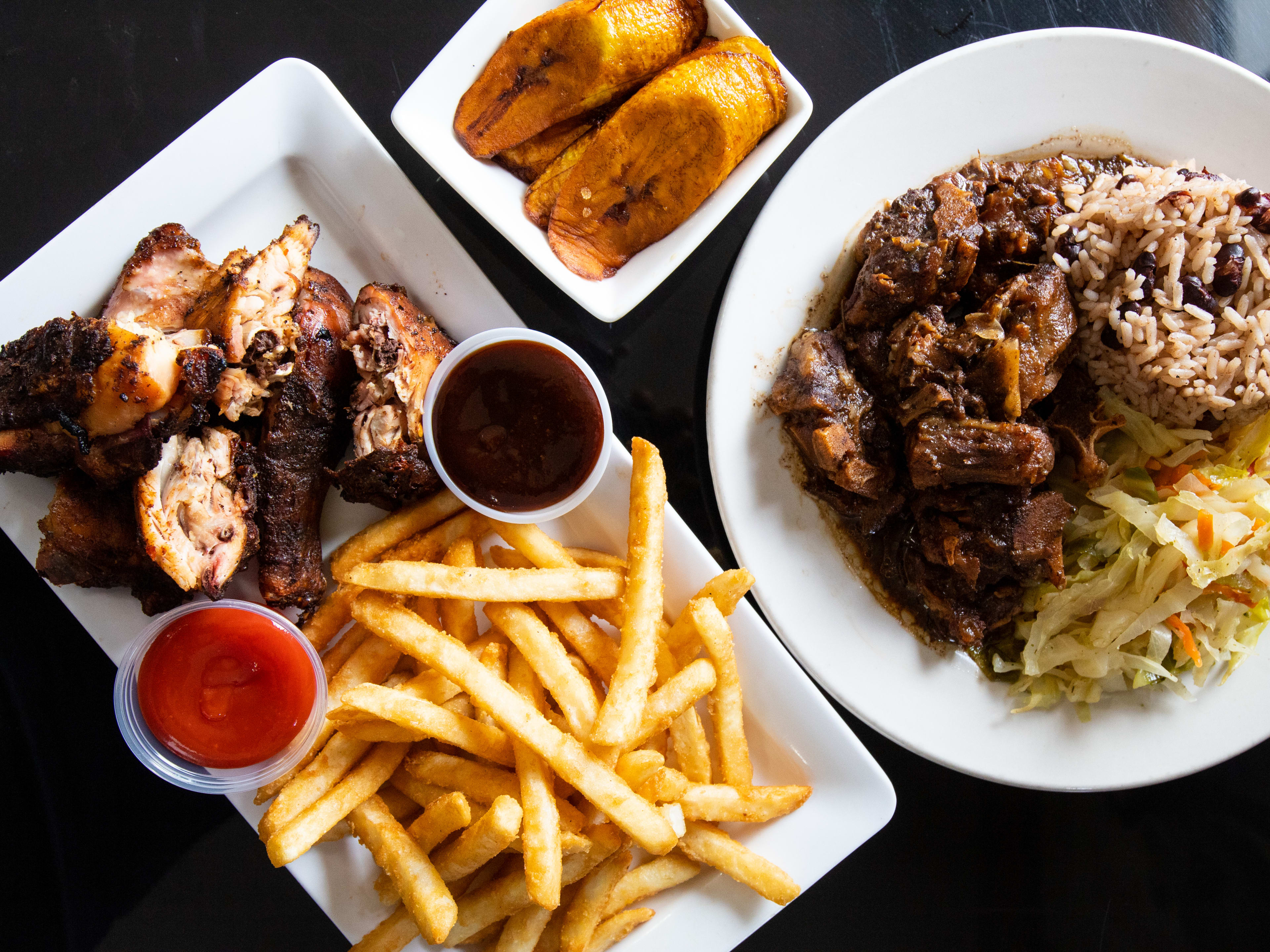 A spread of Jamaican dishes on a table.