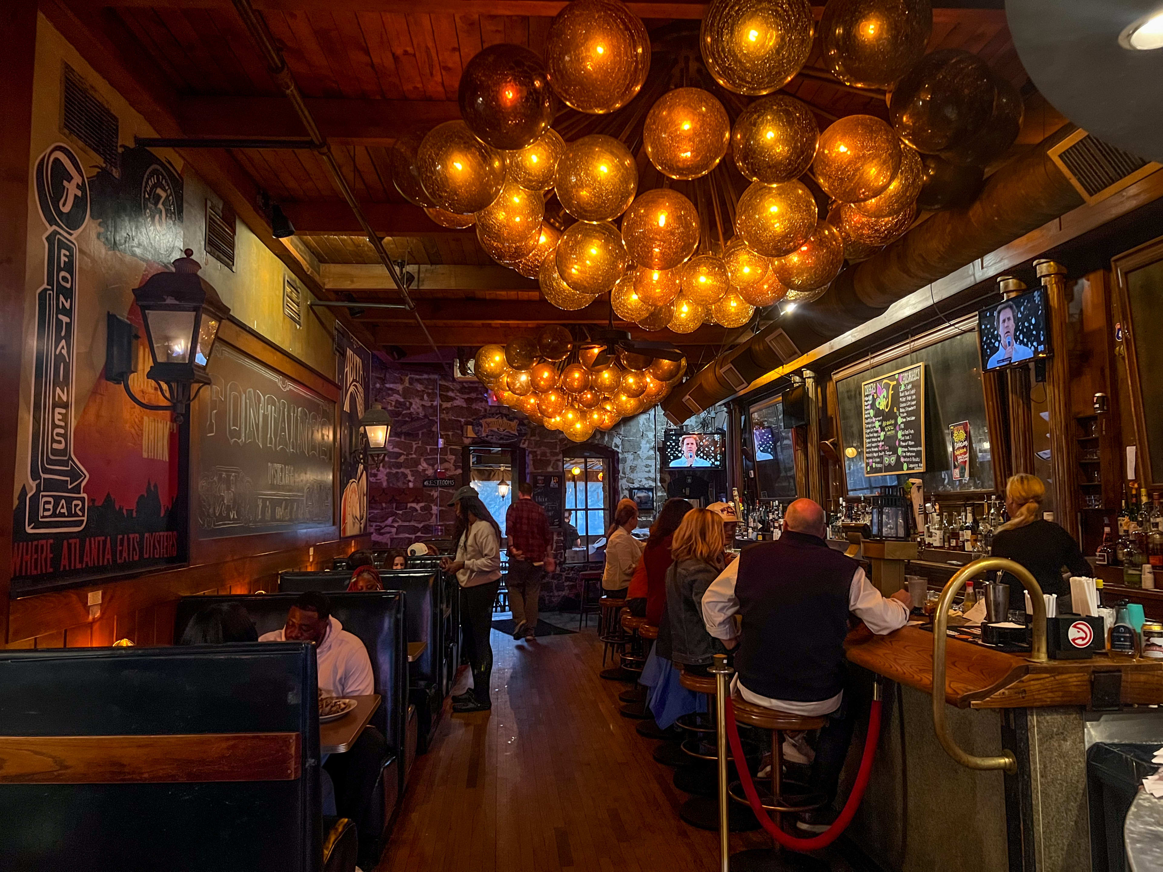 A low-lit bar with wooden booths.