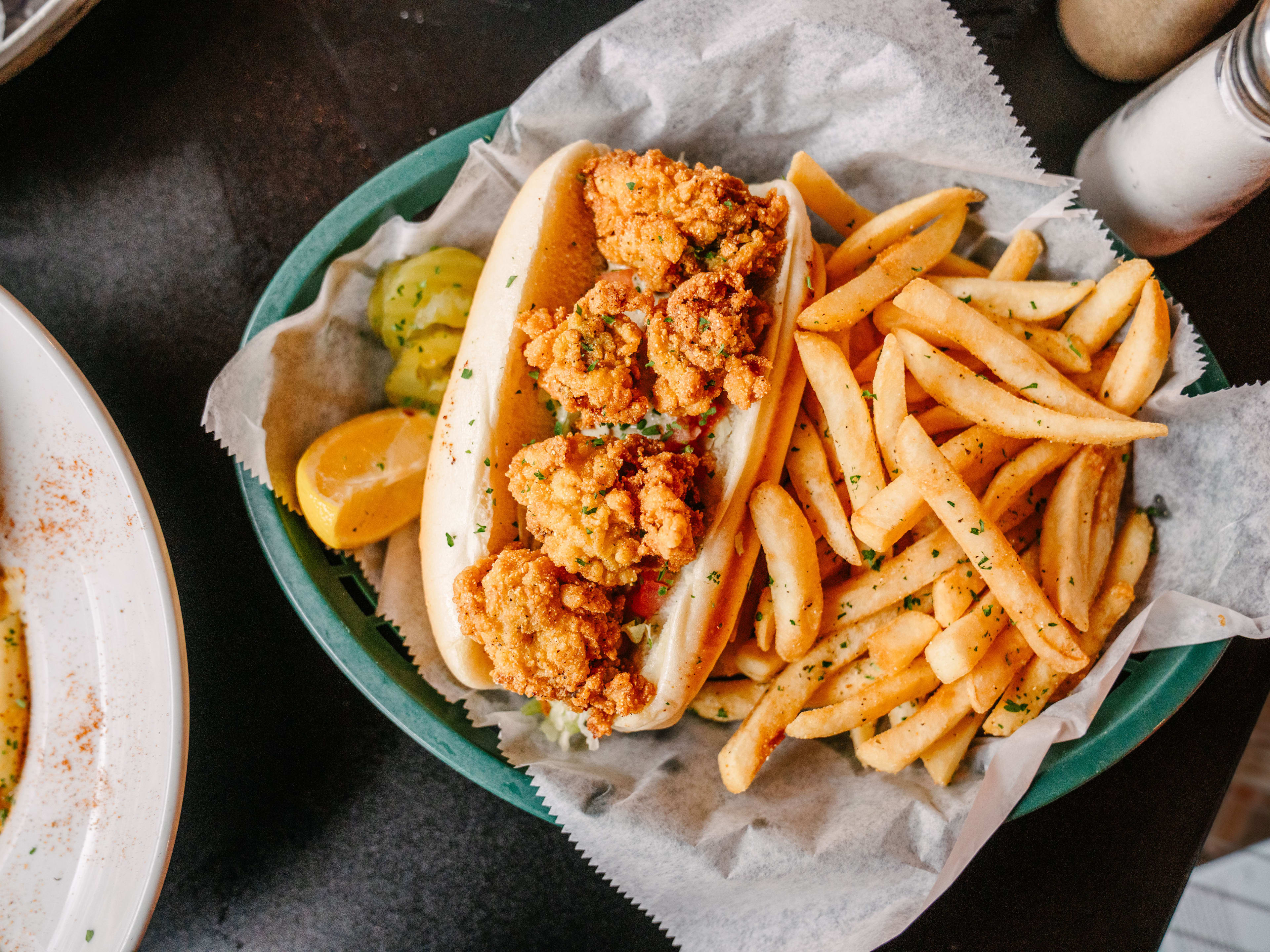 A shrimp po'boy with fries.