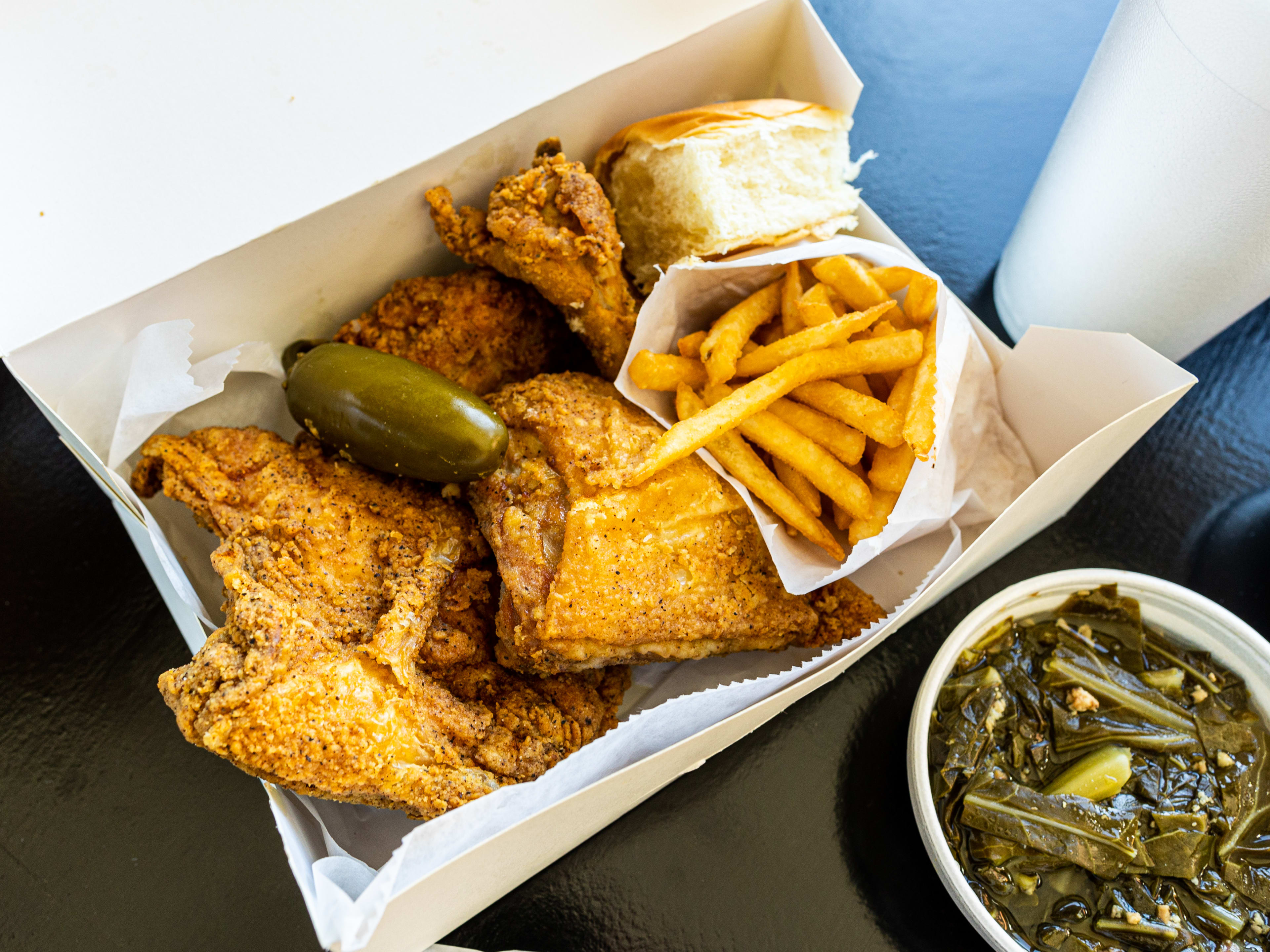 The 4-piece fried chicken feast mixed with a roll and fries from Frenchy's Chicken.