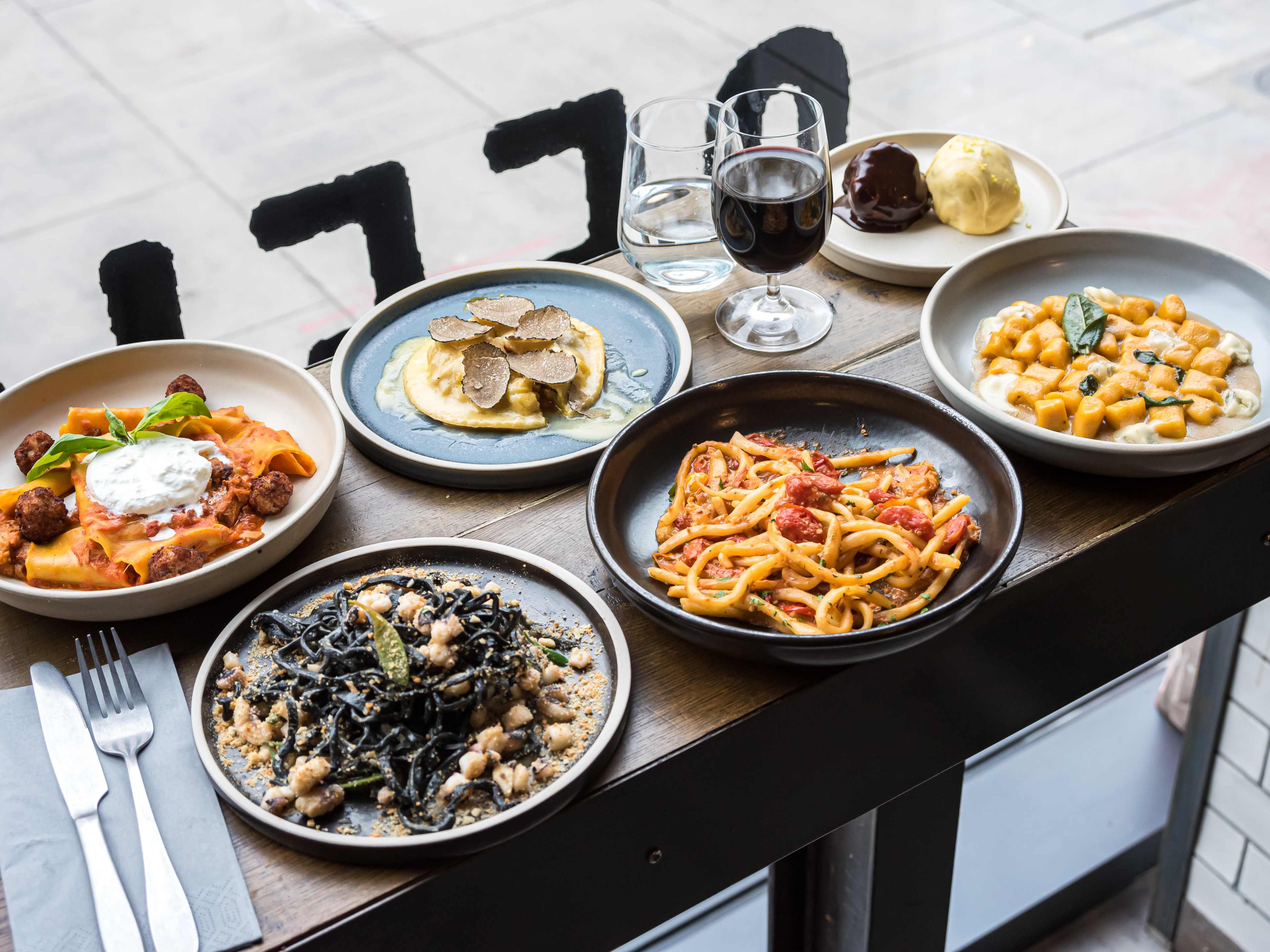 A spread of dishes on a window counter at Officina 00.