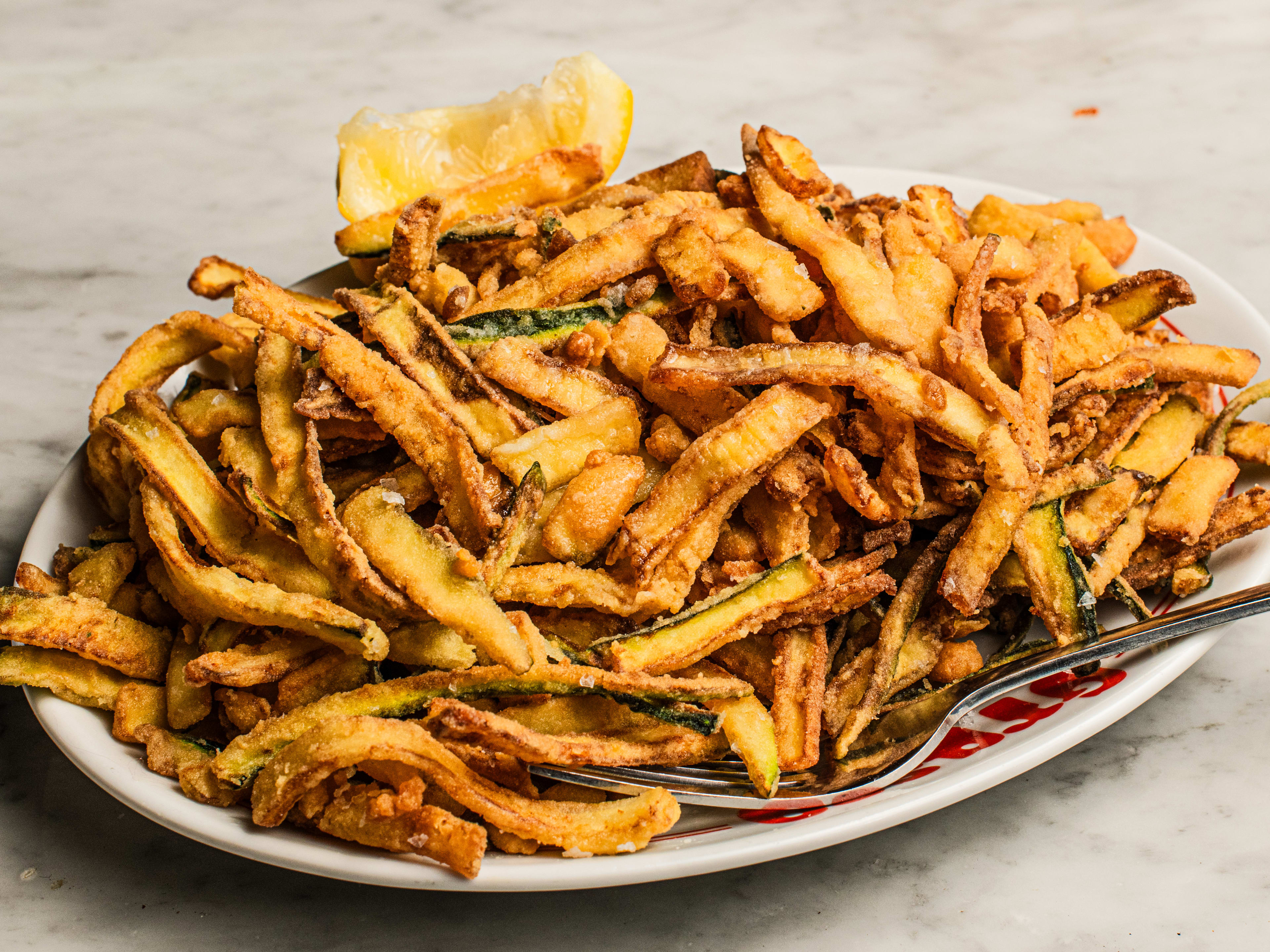 A plate piled high with courgette fries.