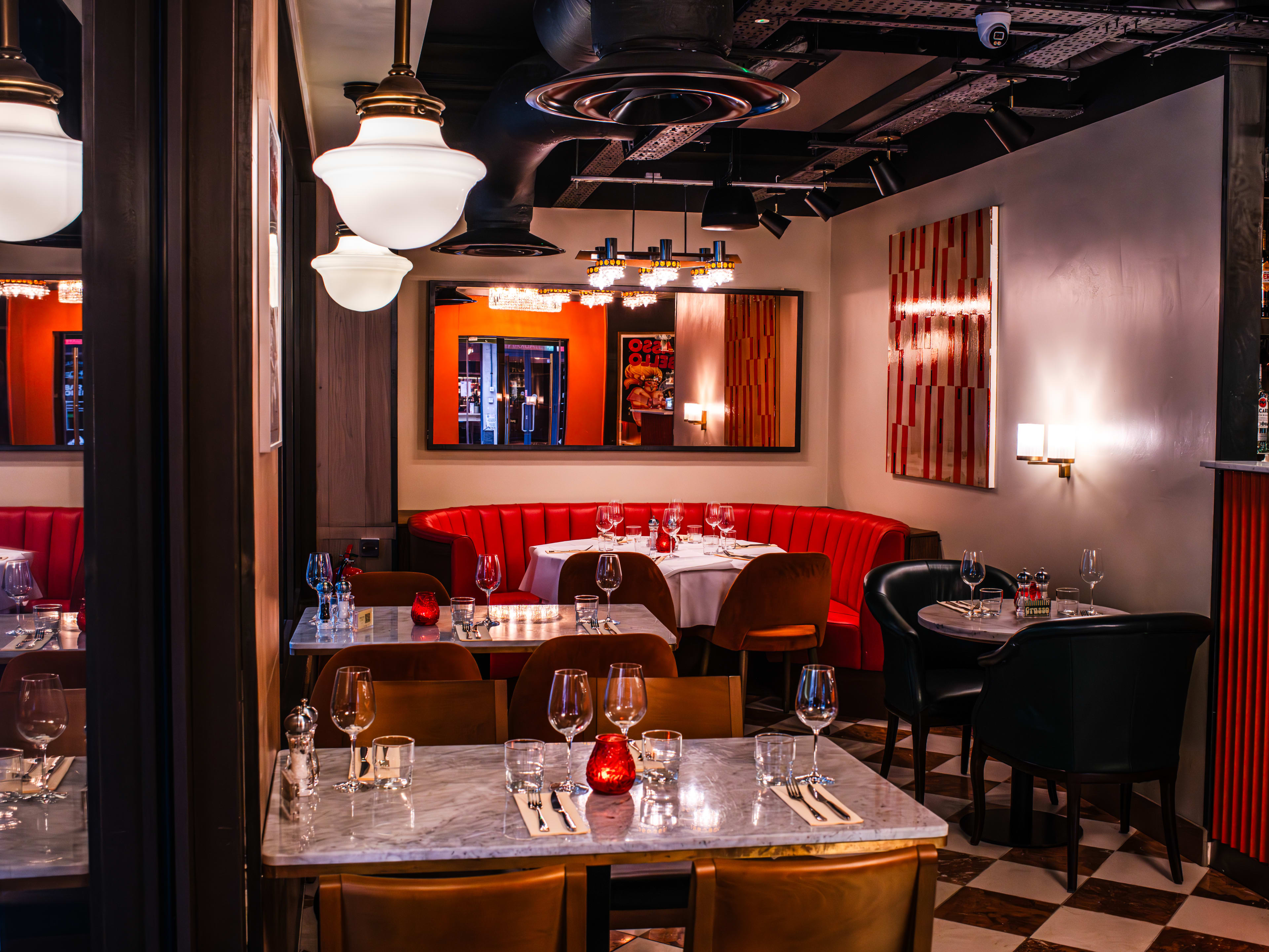 Interior of a restaurant with red booths.