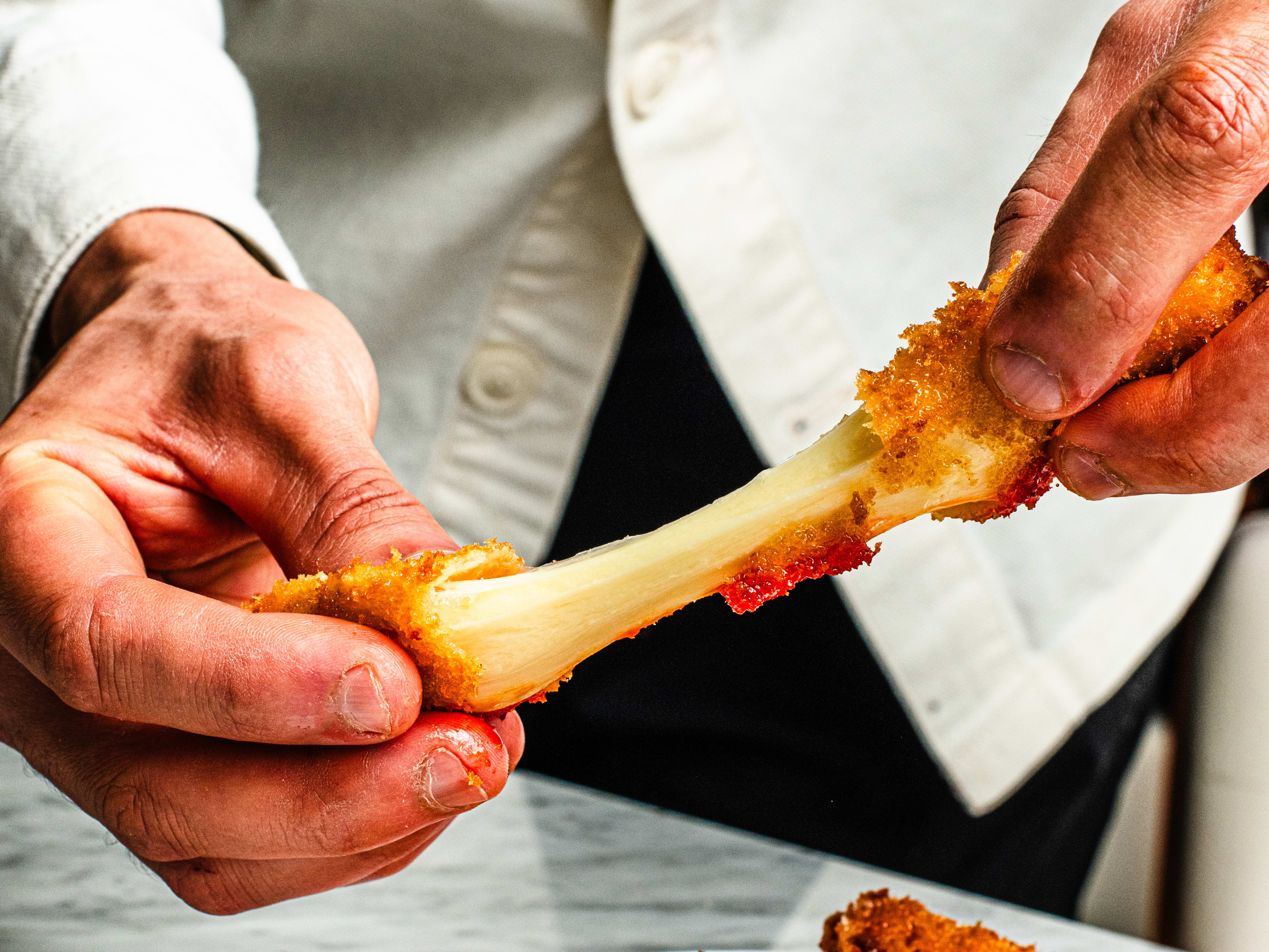 A cheese pull from a mozzarella stick.