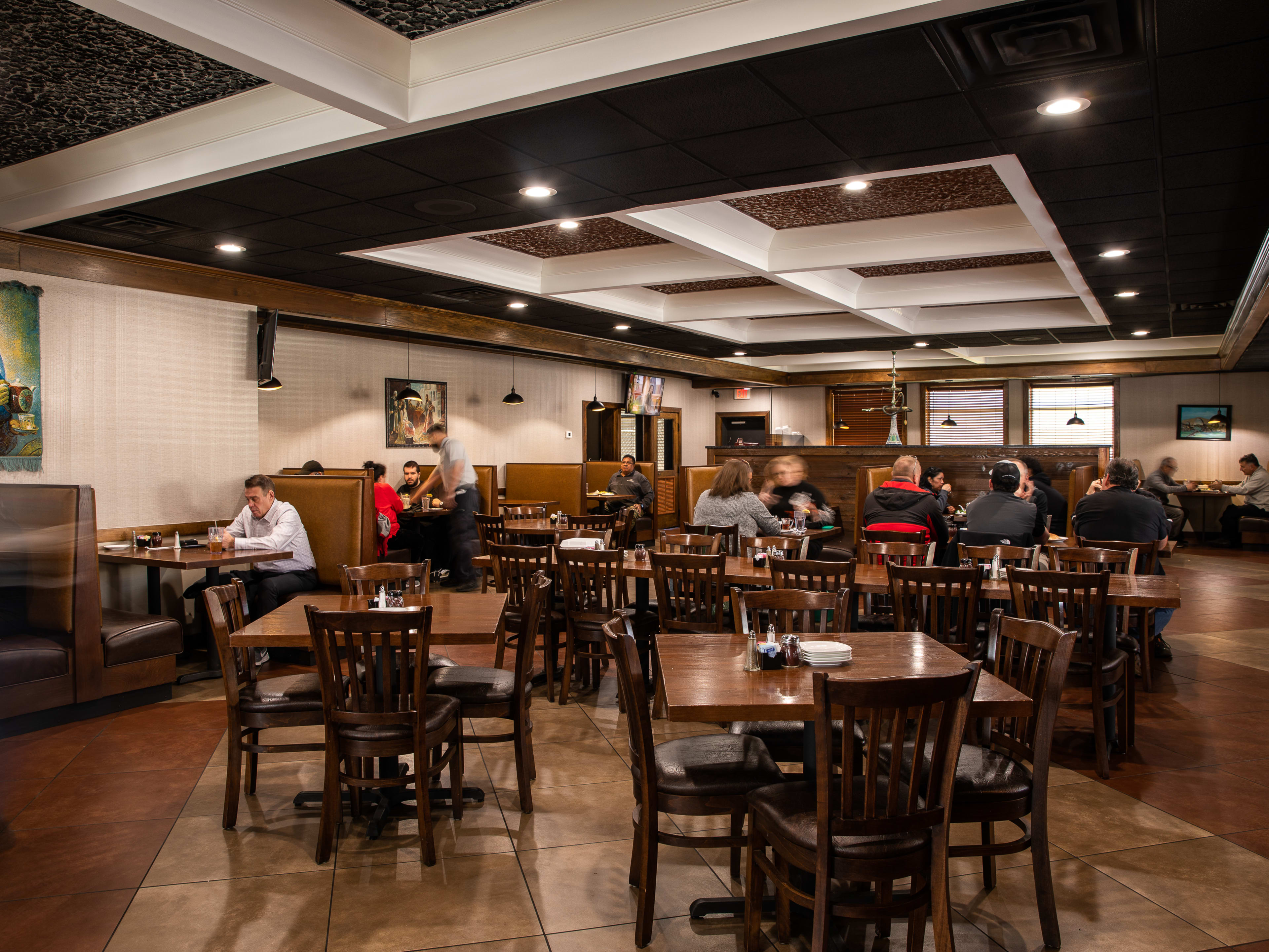 House of Kabob interiors with people seated at dark wooden tables