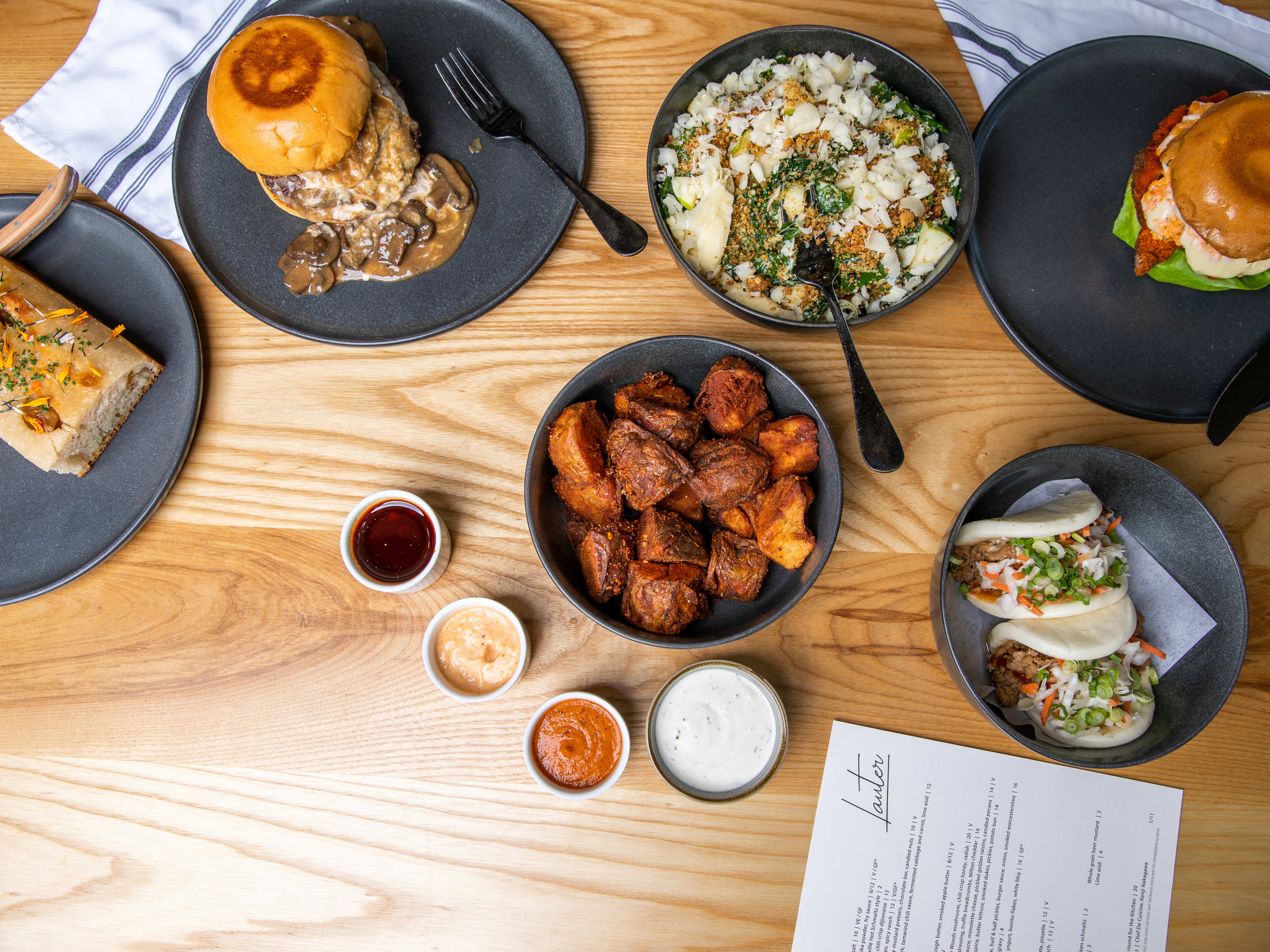 Spread of burger and side dishes at Lauter