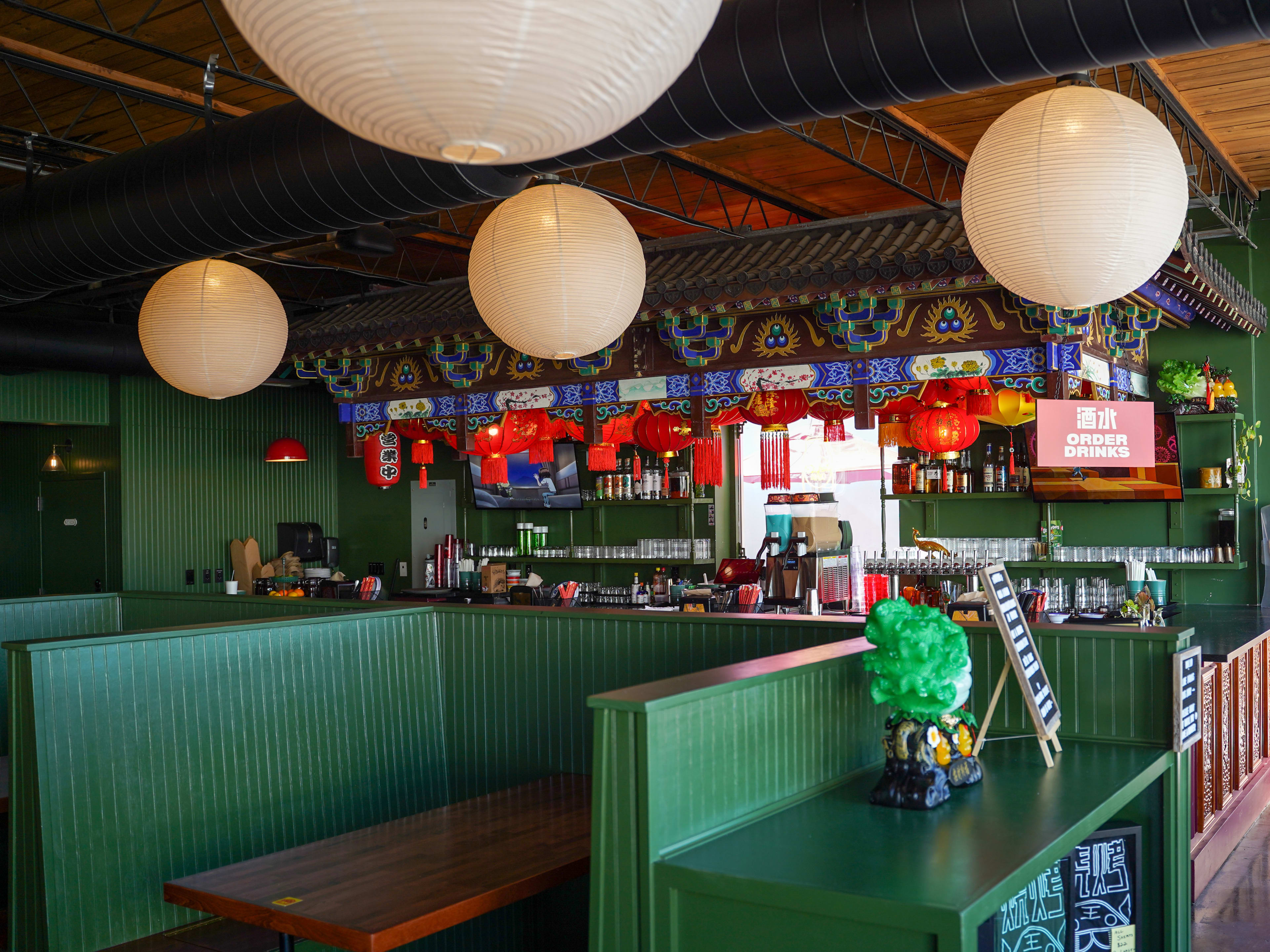 Green interior with round paper lanterns at King BBQ