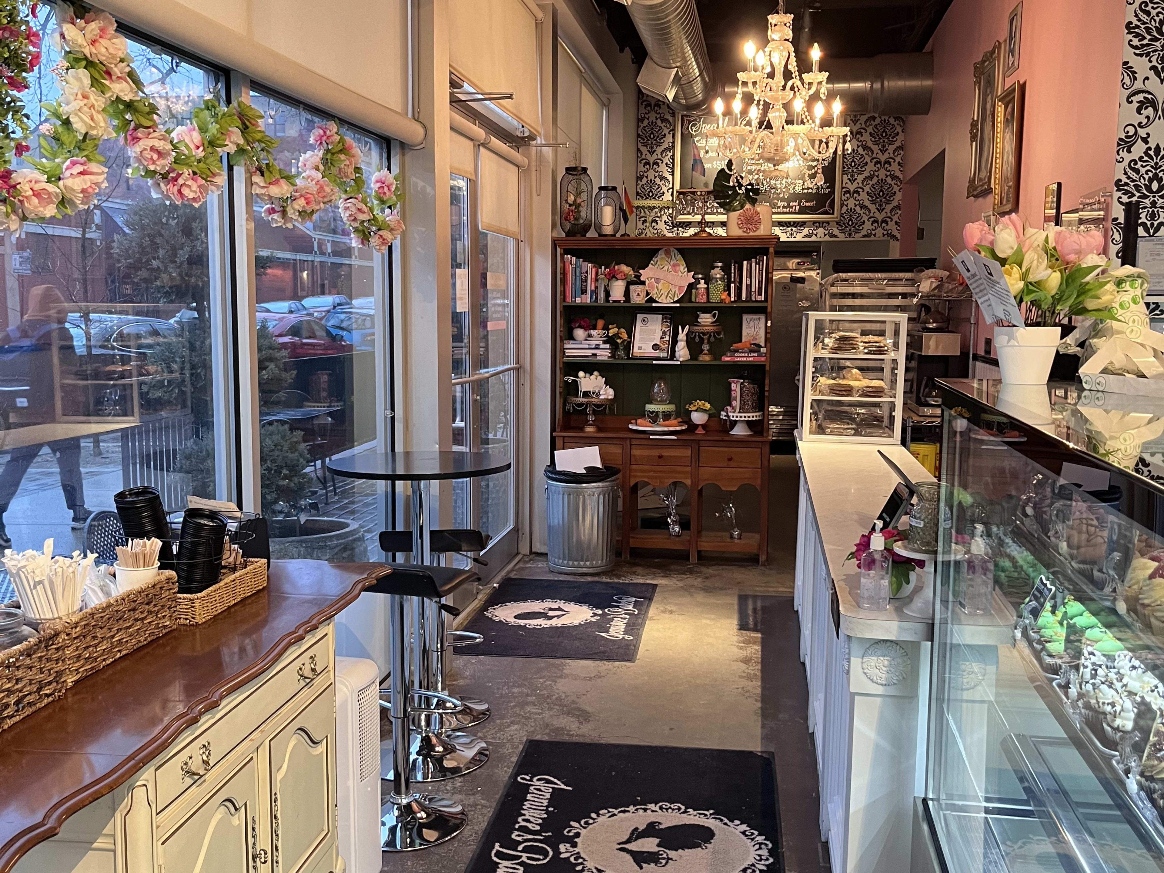 Photo of inside of Jennivee's Bakery with glass case and chandelier.