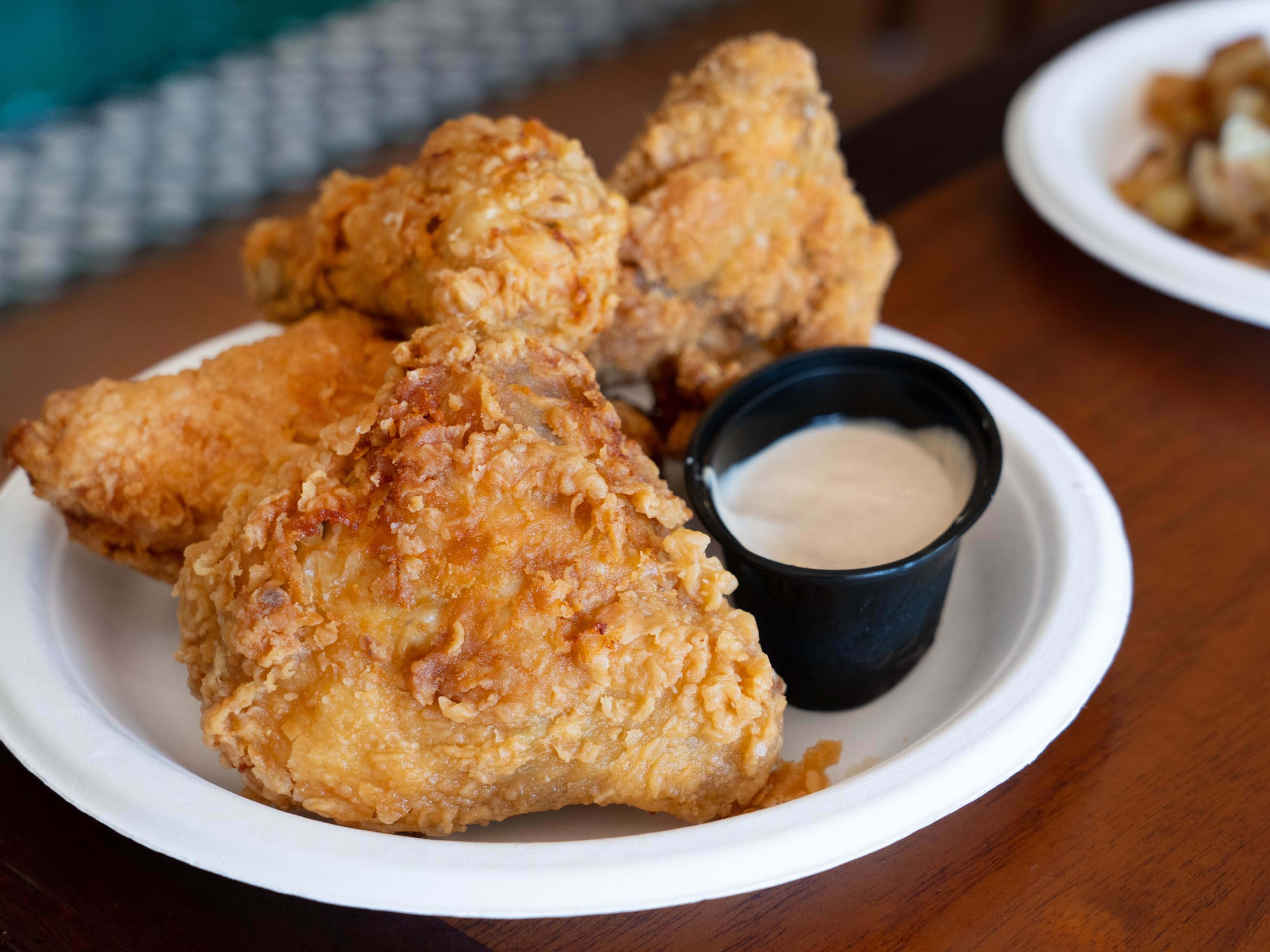 fried chicken pieces with sauce cup on plate