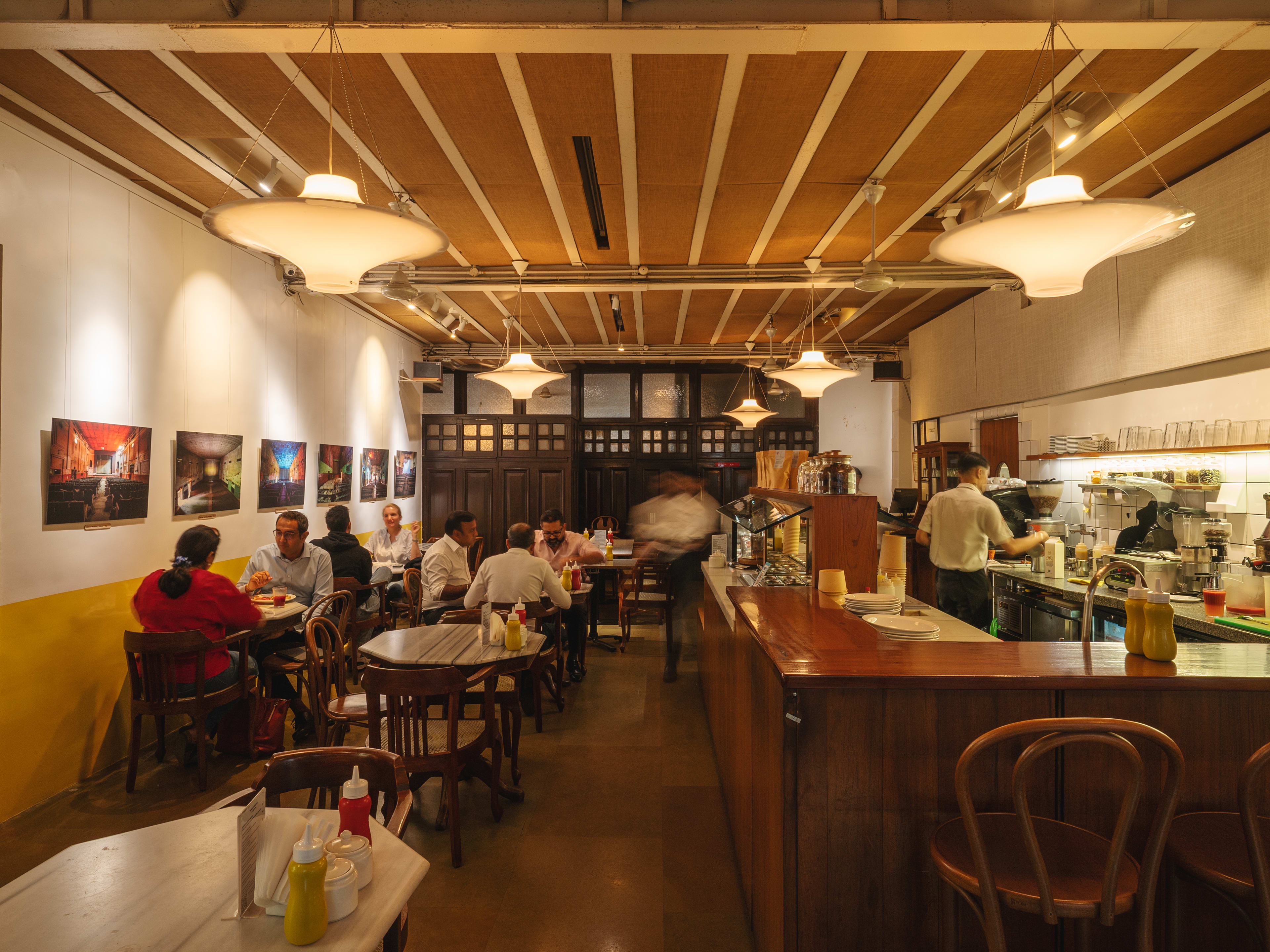 Interior dining room space during busy service at Kala Ghoda Cafe